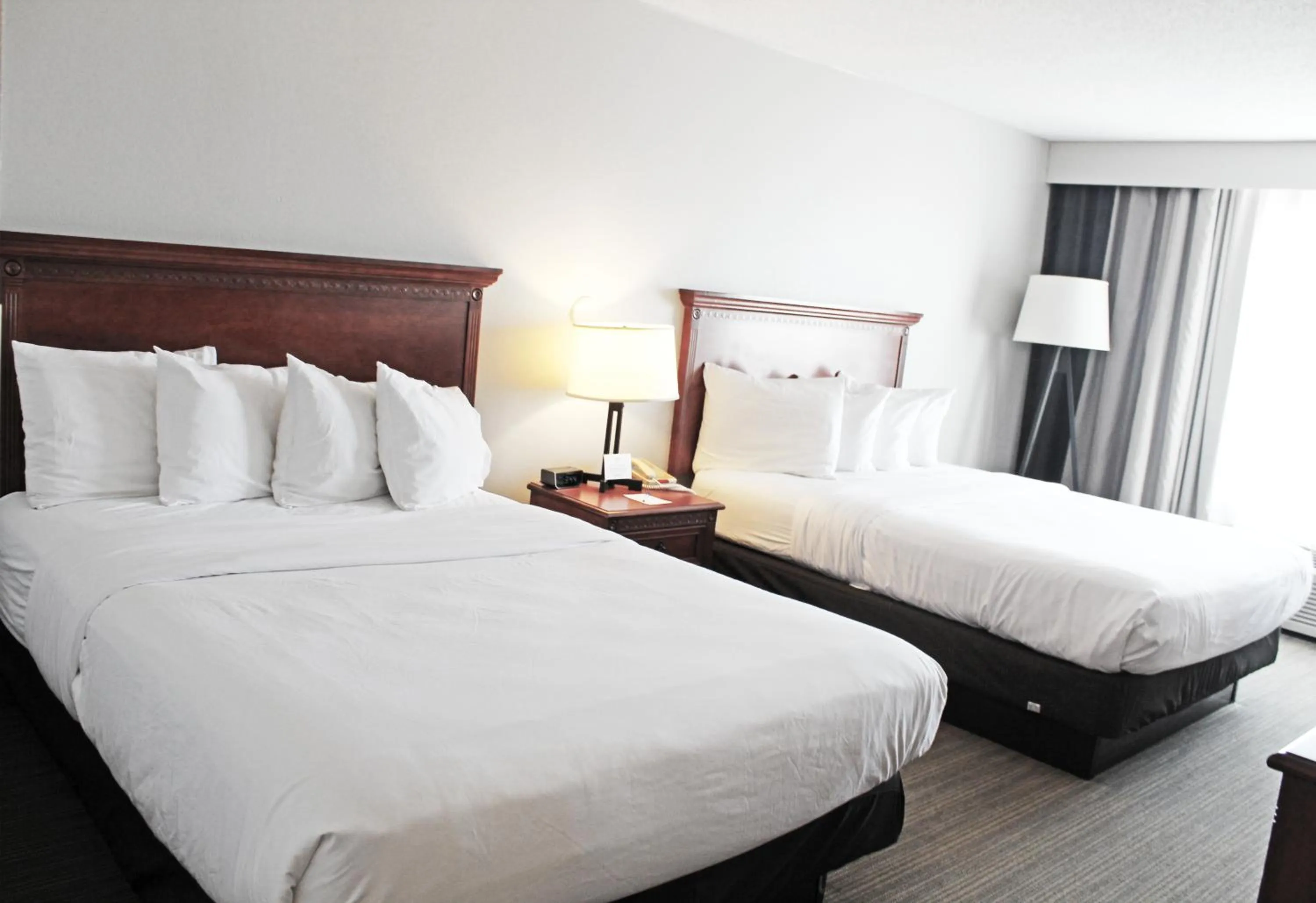 Bed in Independence Stay Hotel & Suites