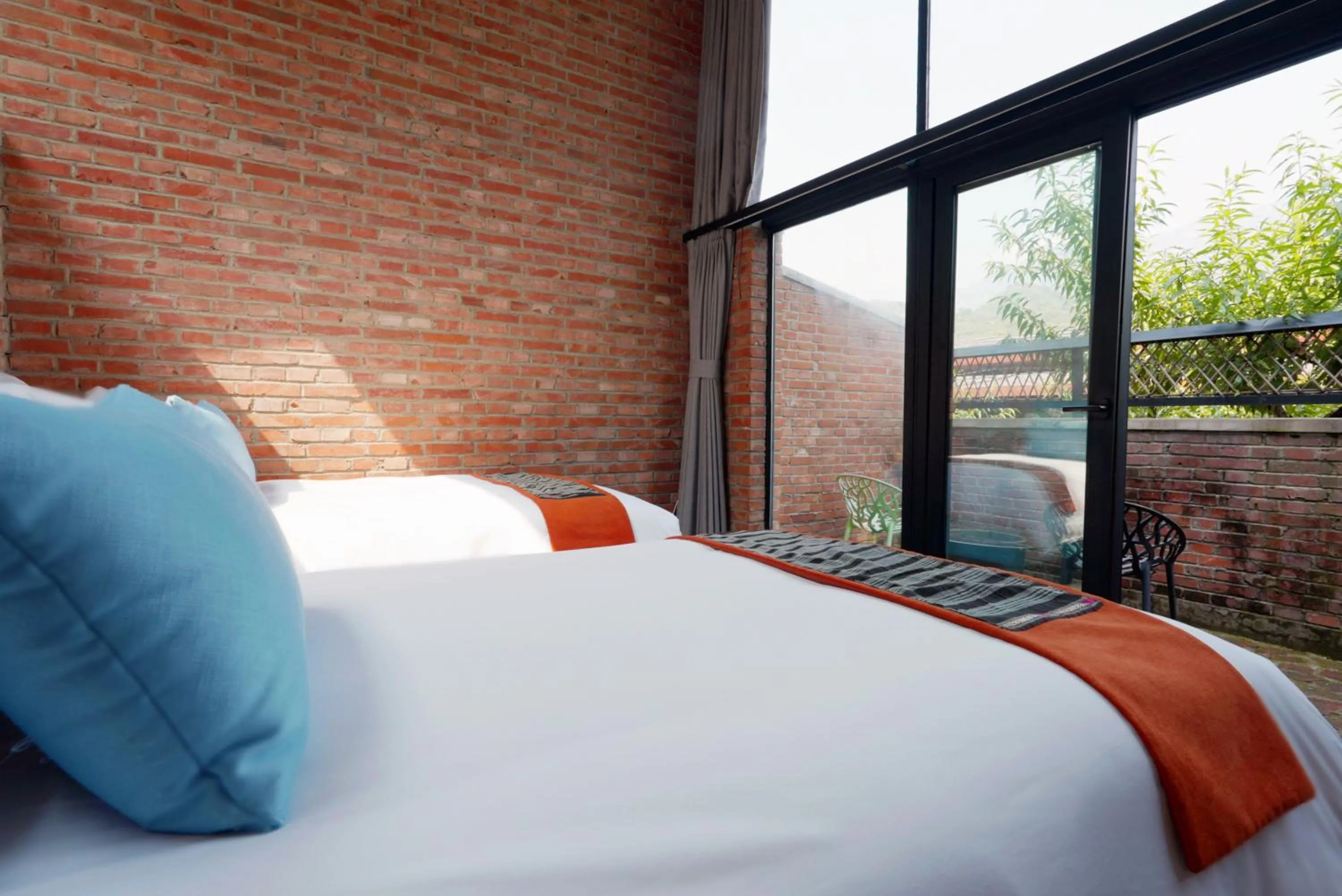 Bed in Brickyard Retreat at Mutianyu Great Wall Adjoin to Mutianyu Great Wall - Room with the View of Great Wall - Jacuzzi with the View of Great Wall - Vehicle Shuttle Service - International Catering - SPA& Nail Beauty Facilities