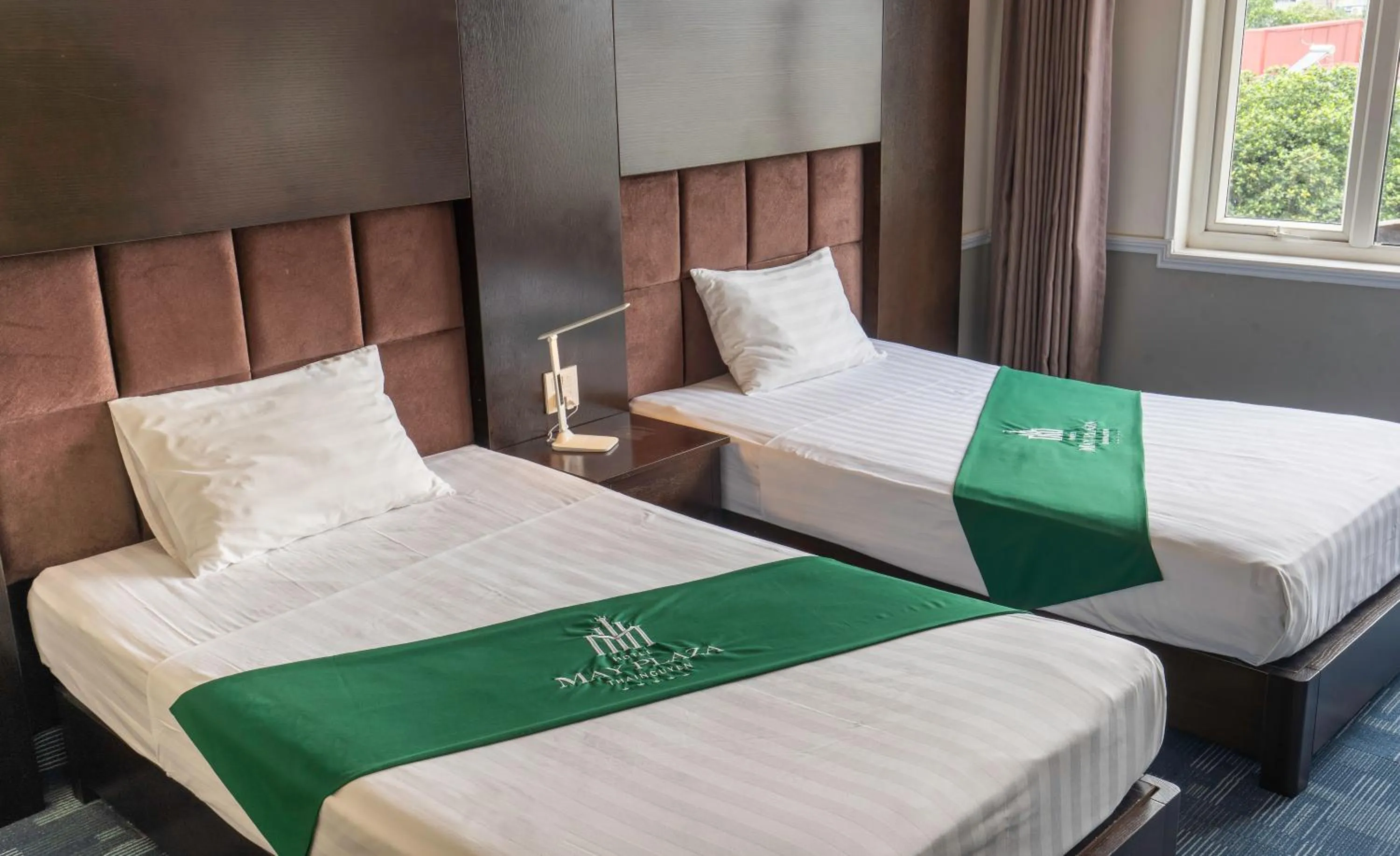 Bed in MAY PLAZA HOTEL