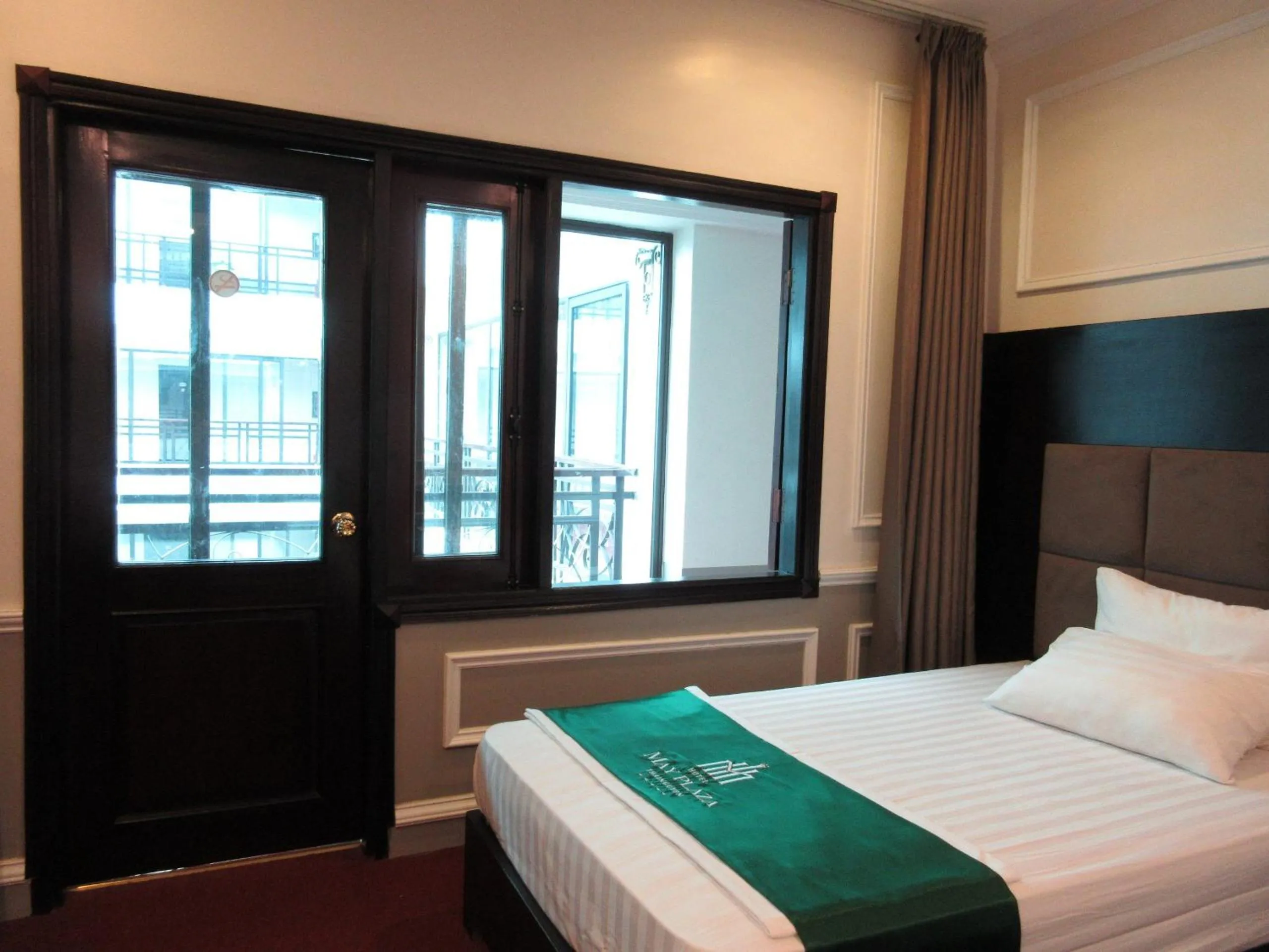 Bed in MAY PLAZA HOTEL