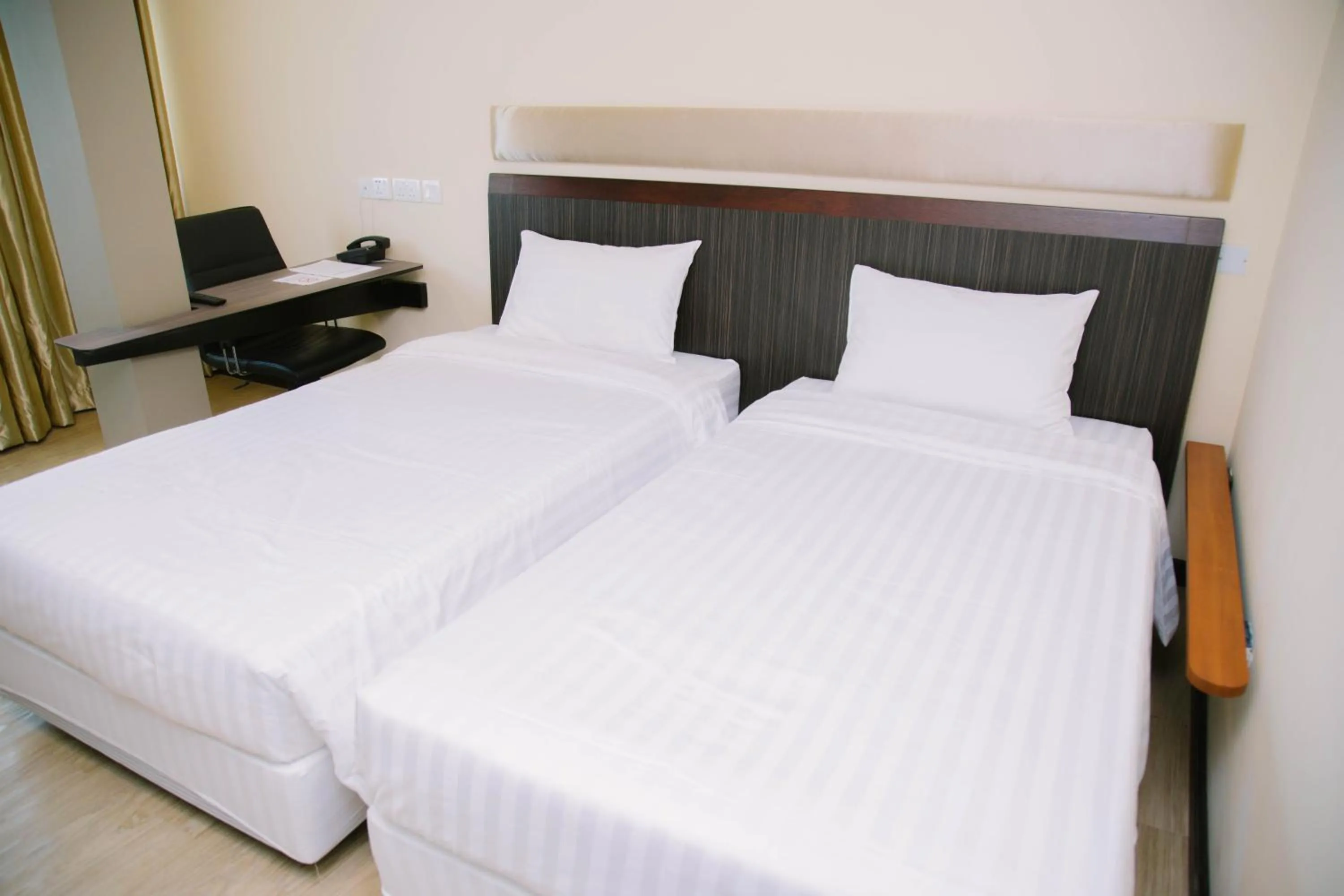 Bed in The Capital Residence Suites