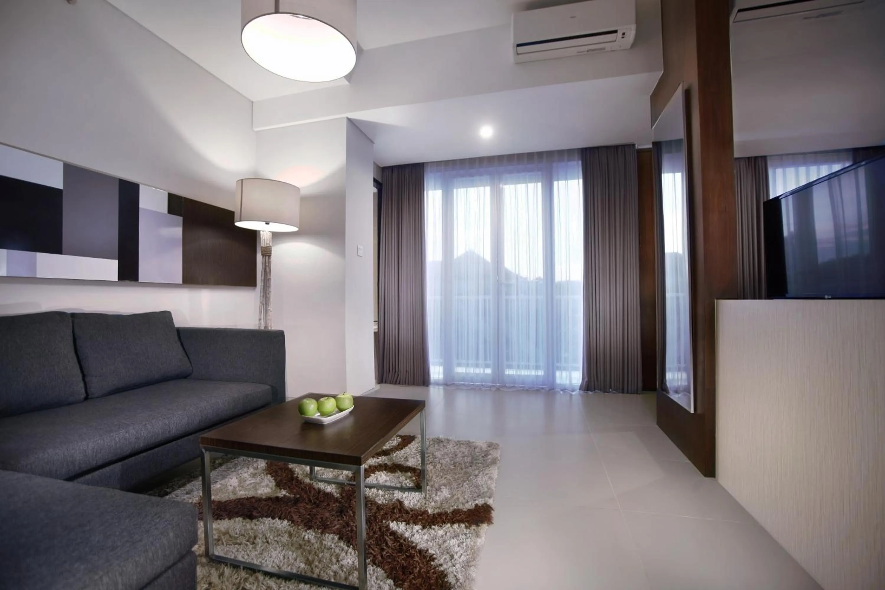 Living room in Neo Denpasar by ASTON