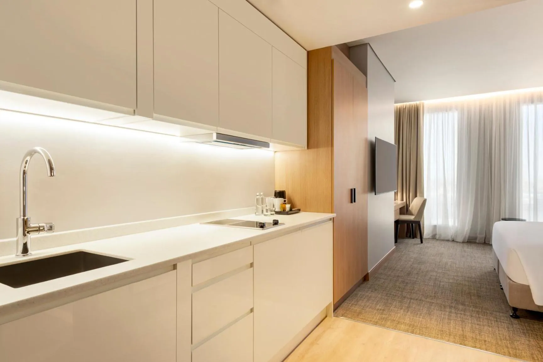 Kitchen or kitchenette, Bed in Radisson Hotel & Residence Riyadh Olaya