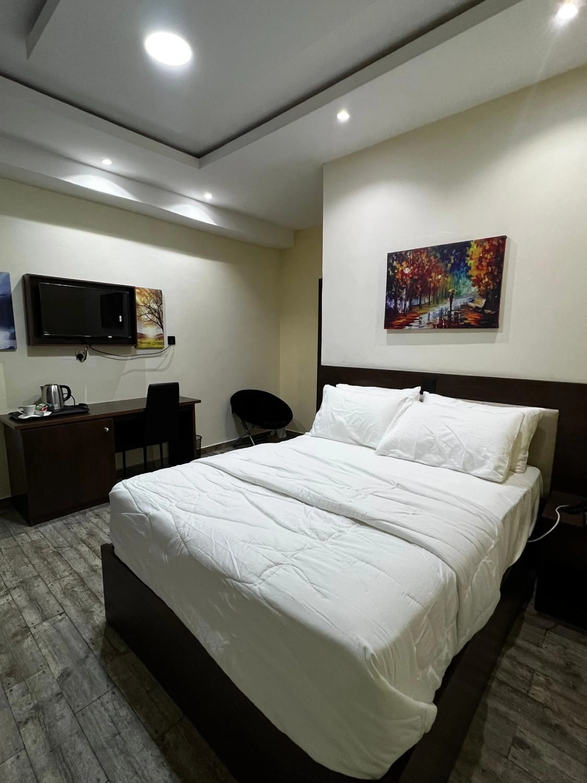 Bed in Fragrance Apartments and Suites