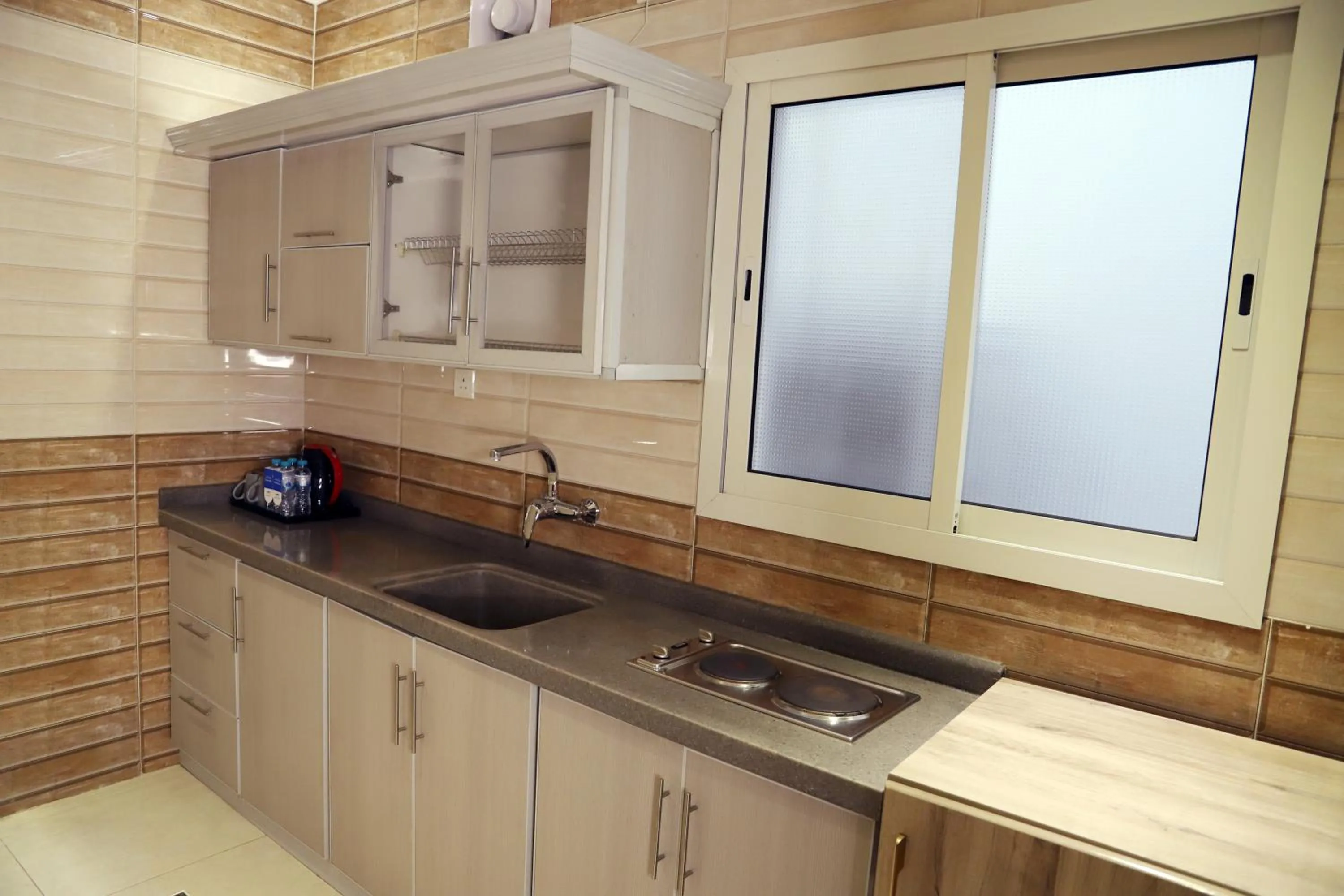 Kitchen or kitchenette in Sunrise Suites