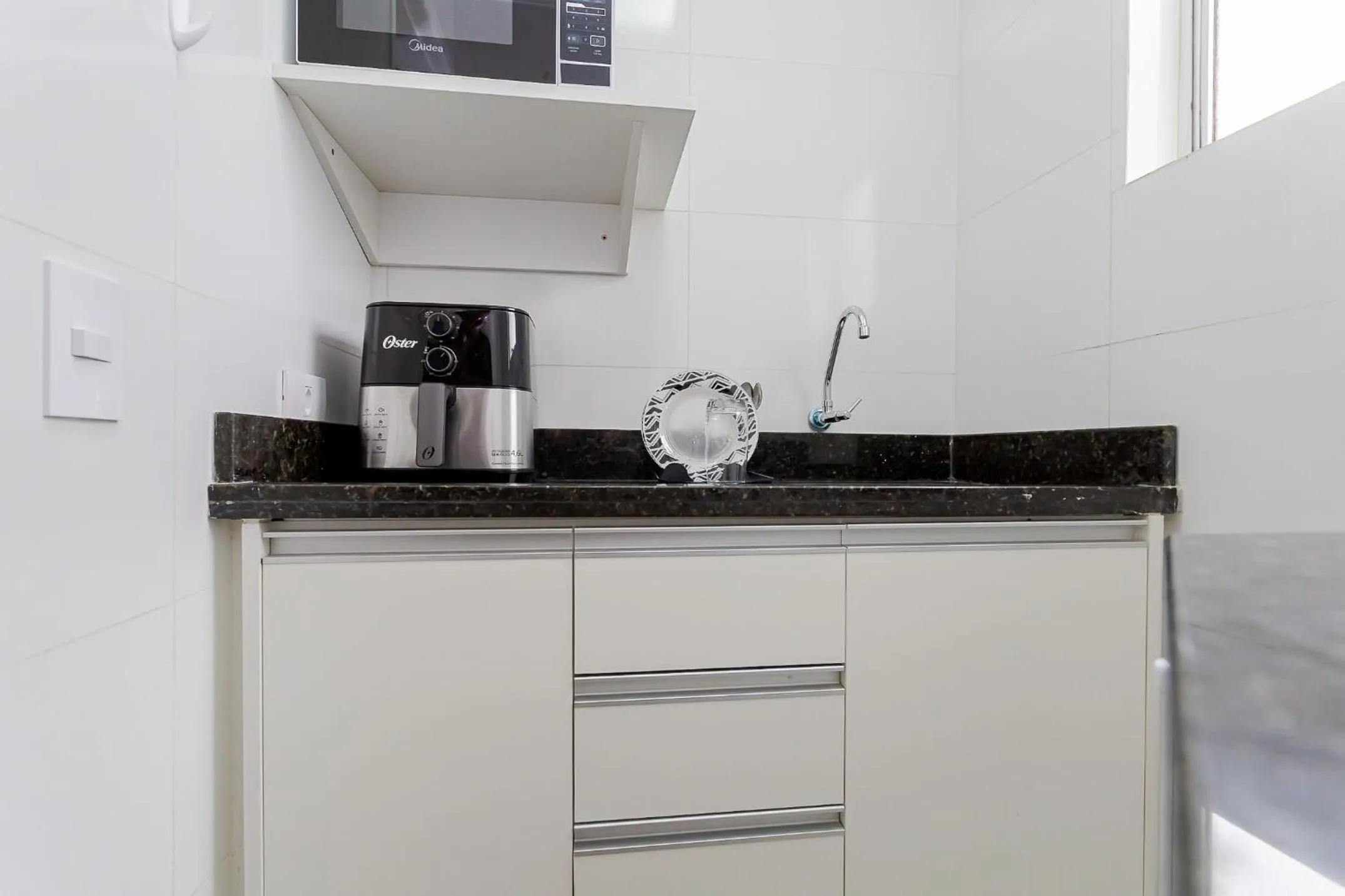 Kitchen or kitchenette in Ed. Charlie Chaplin | Prédio no coração de Curitiba | Gonzaga Stays