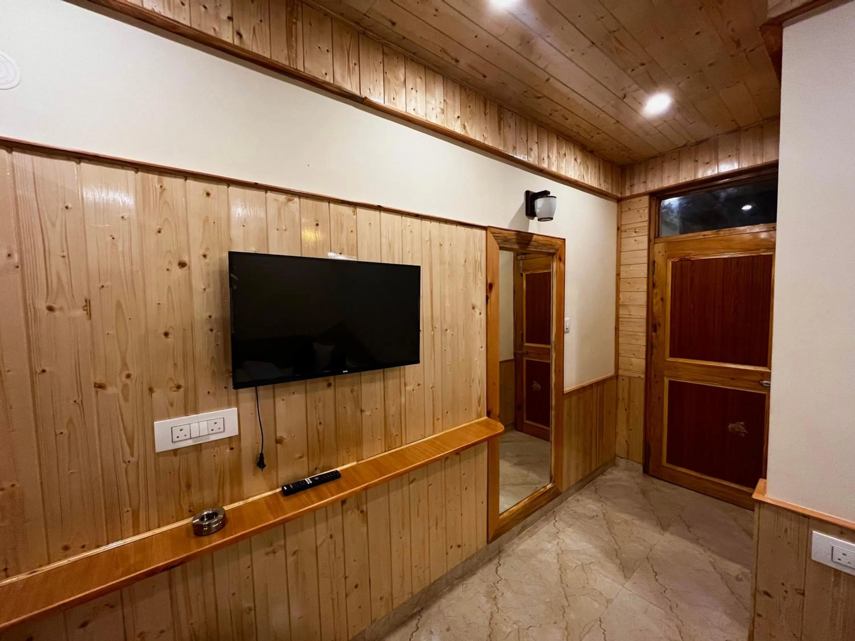 TV and multimedia in Hotel Mid Orchard Kasol l River Side -Pure Veg Hotel