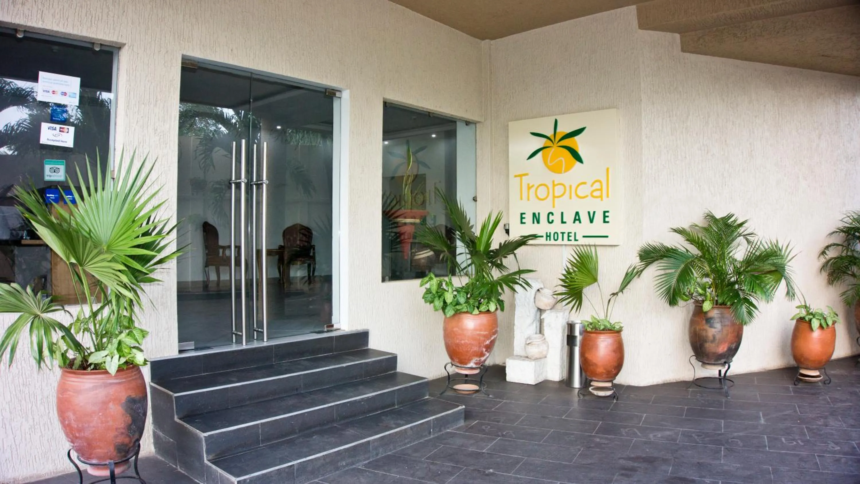 Property logo or sign in Tropical Enclave Hotel