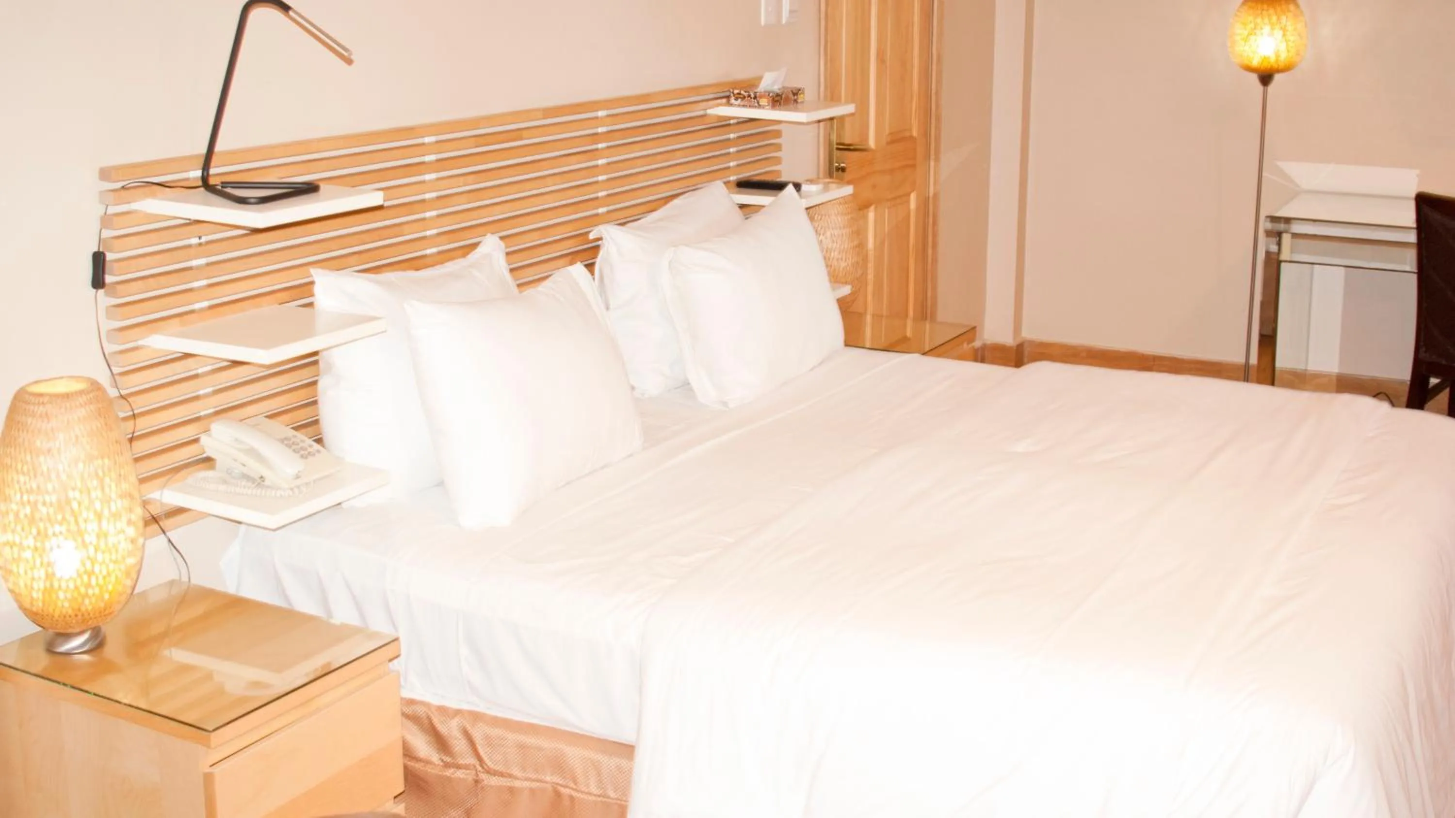 Bed in Tropical Enclave Hotel