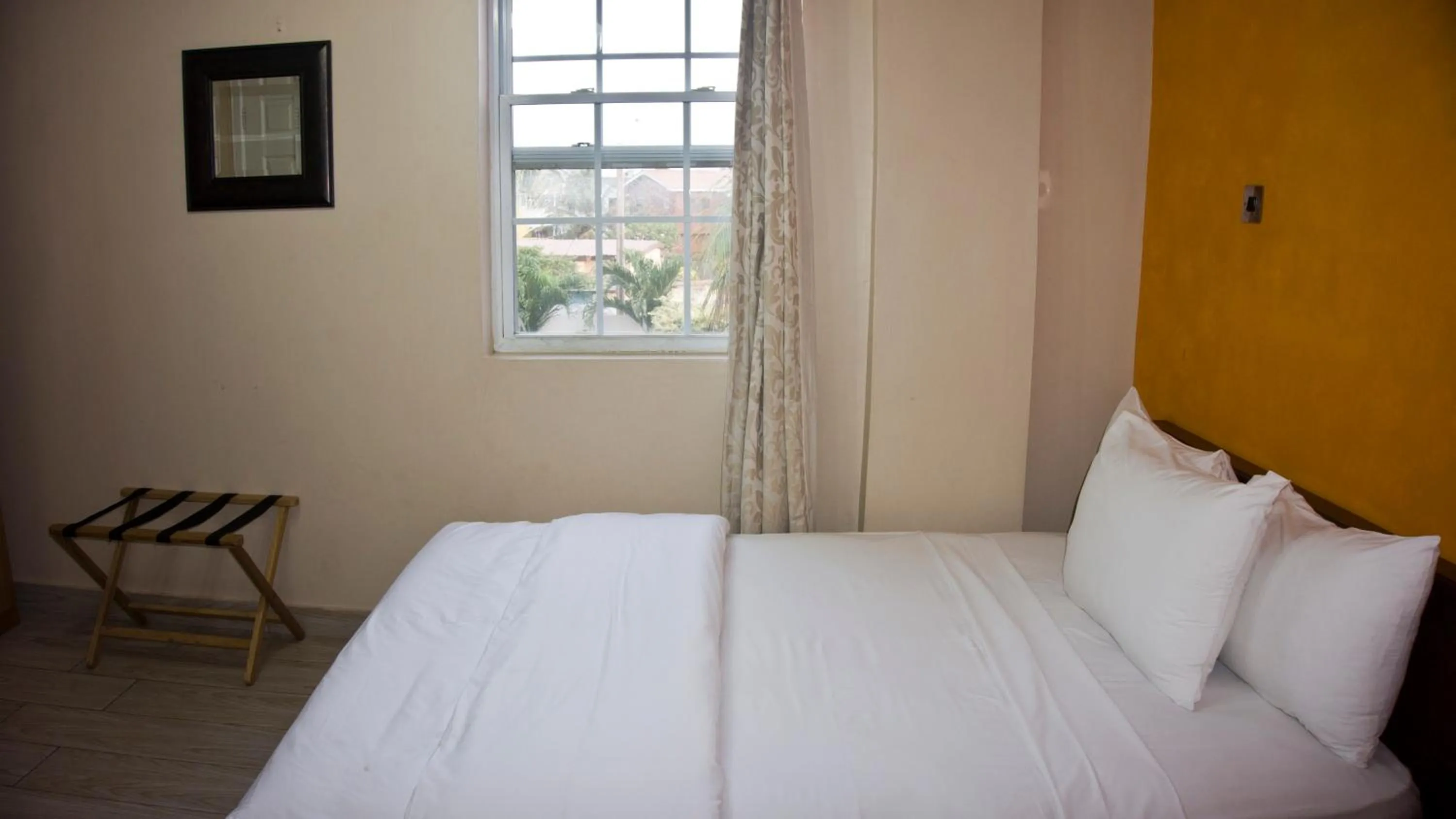 Bed in Tropical Enclave Hotel