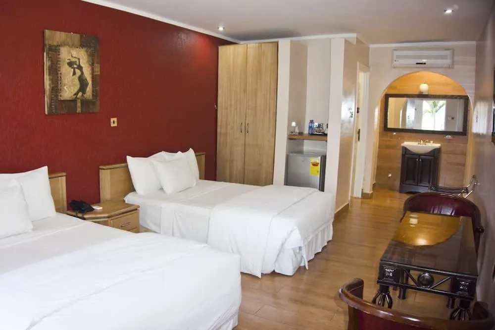 Bed in Tropical Enclave Hotel