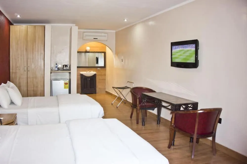 Bed in Tropical Enclave Hotel