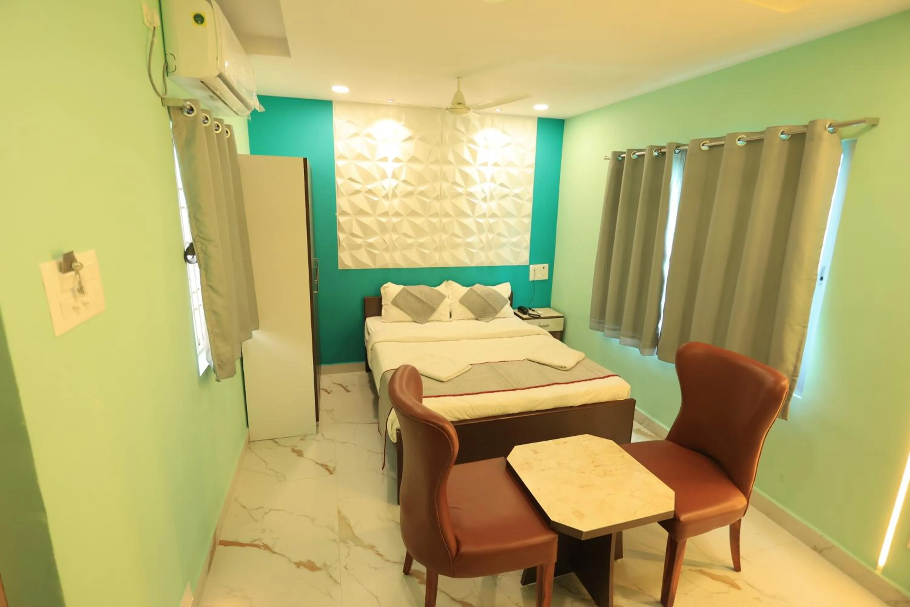 Seating area, Bed in Kailasaa Residency