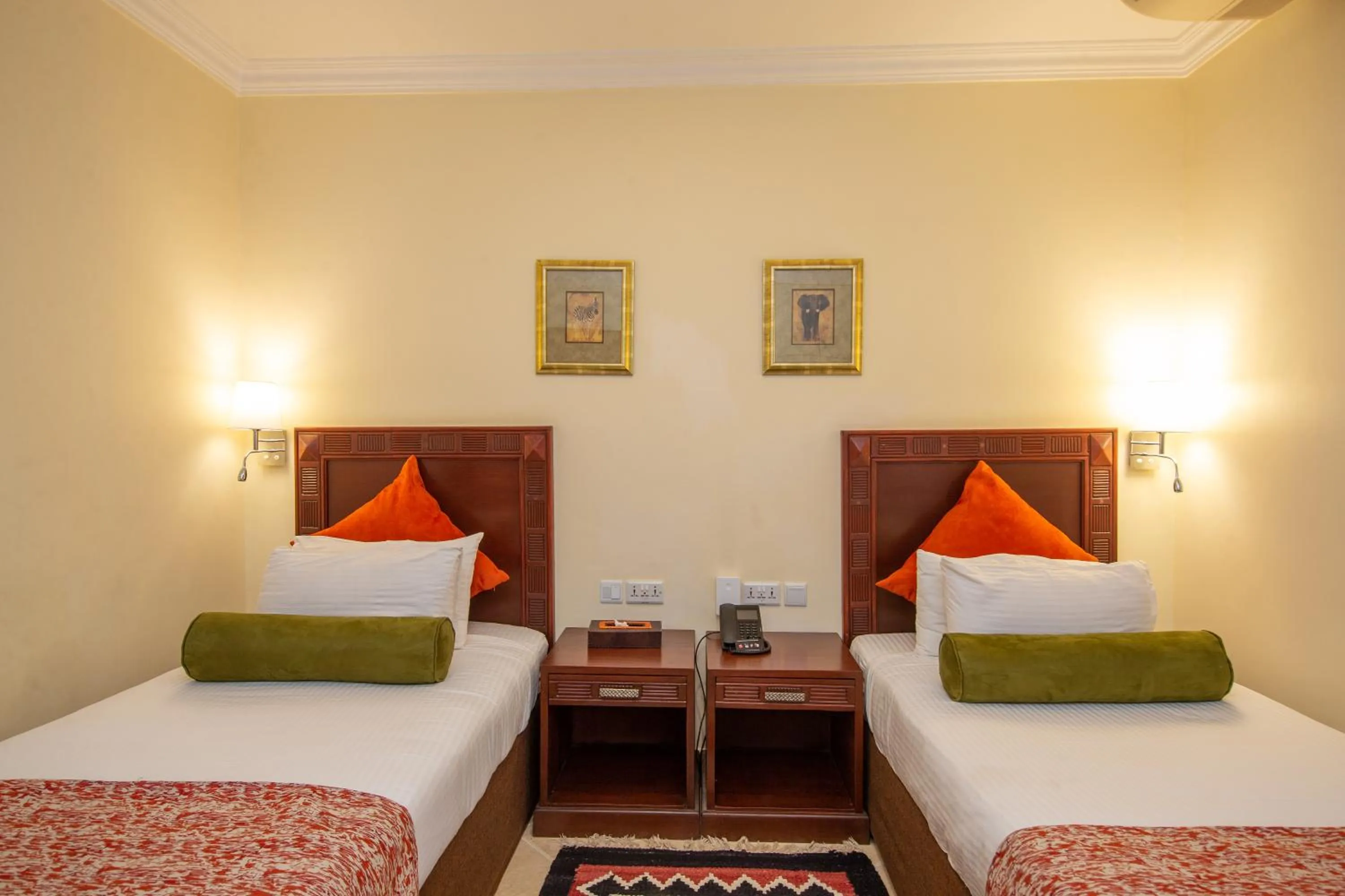 Bed in African Tulip Hotel