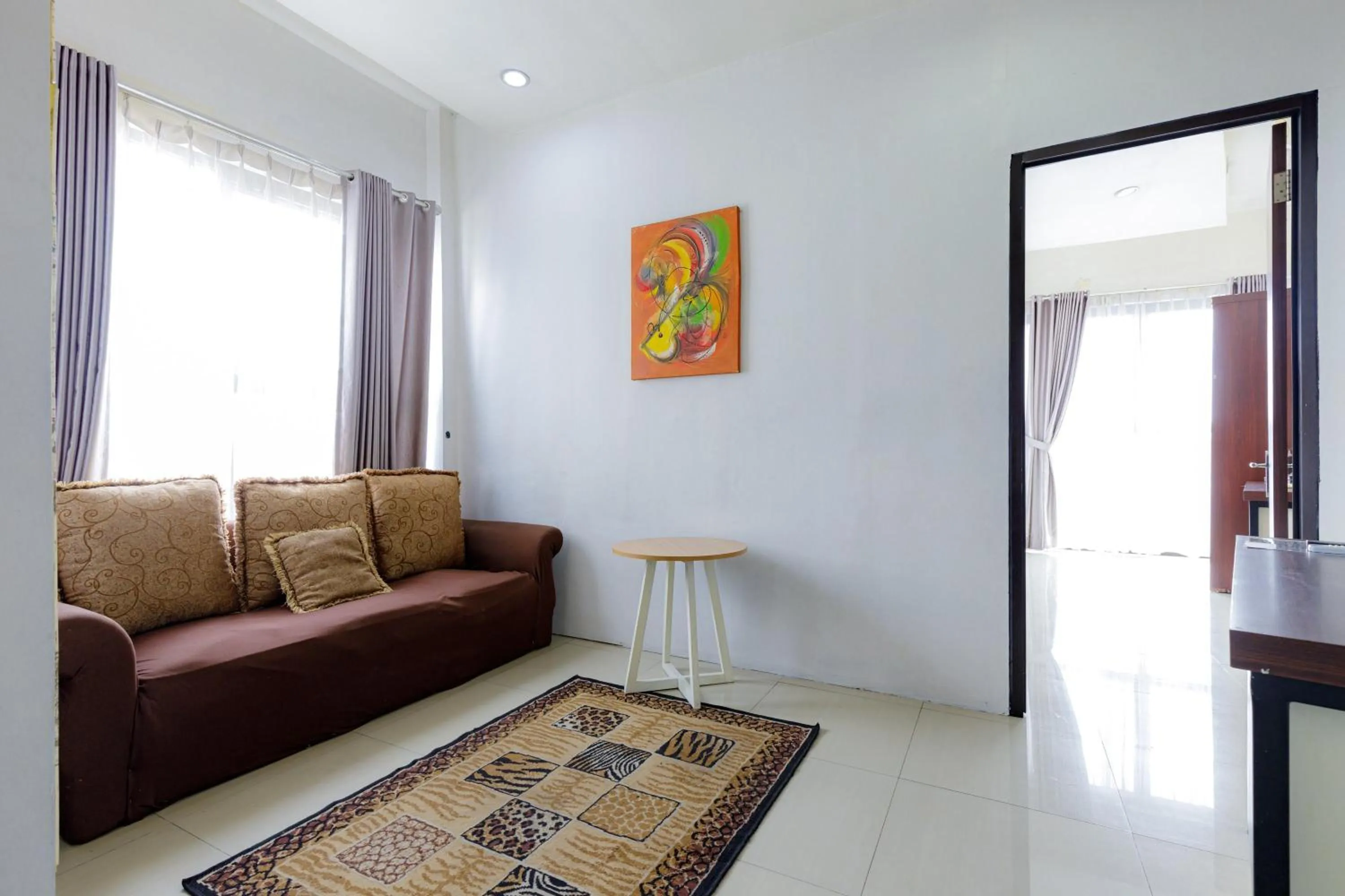 Living room in Urbanview SRB near Mall Ciputra Cibubur by RedDoorz