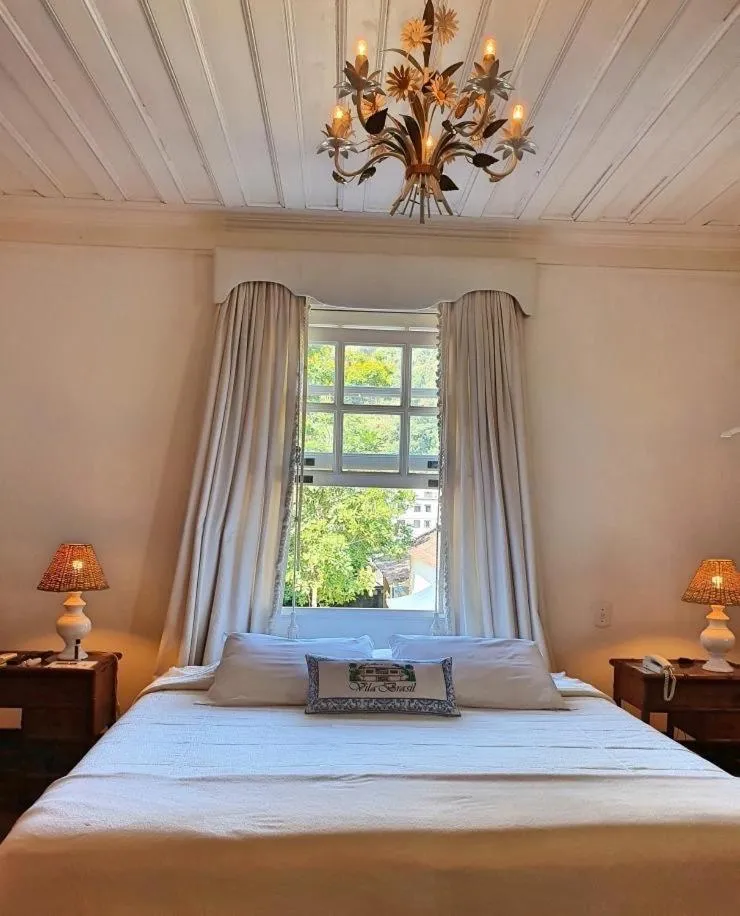 Bed in Pousada Vila Brasil