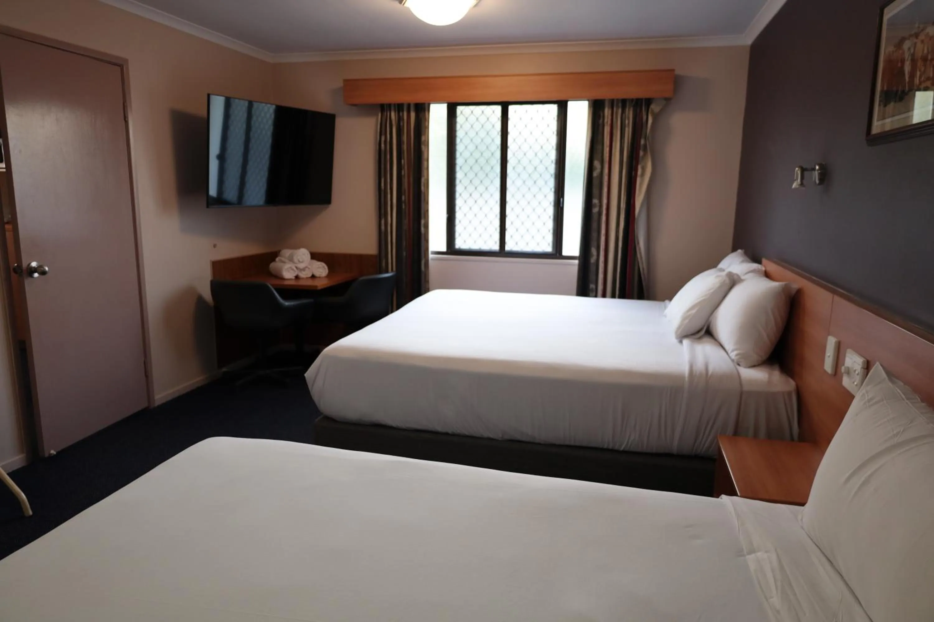 Bed in SunPalms Motel