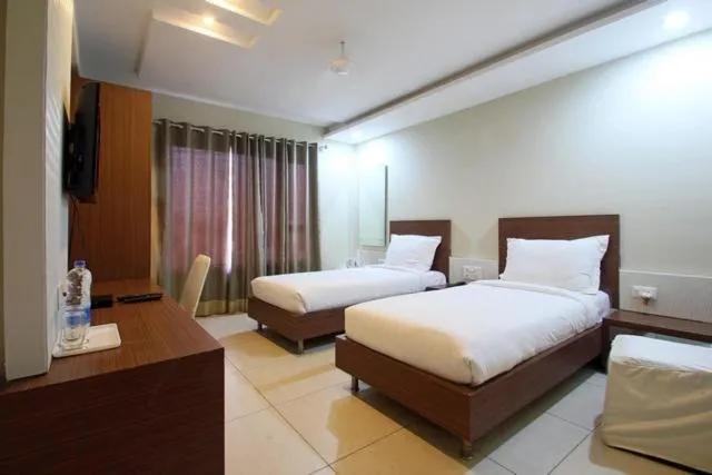 Bed in Hotel Sheela Shree Plaza