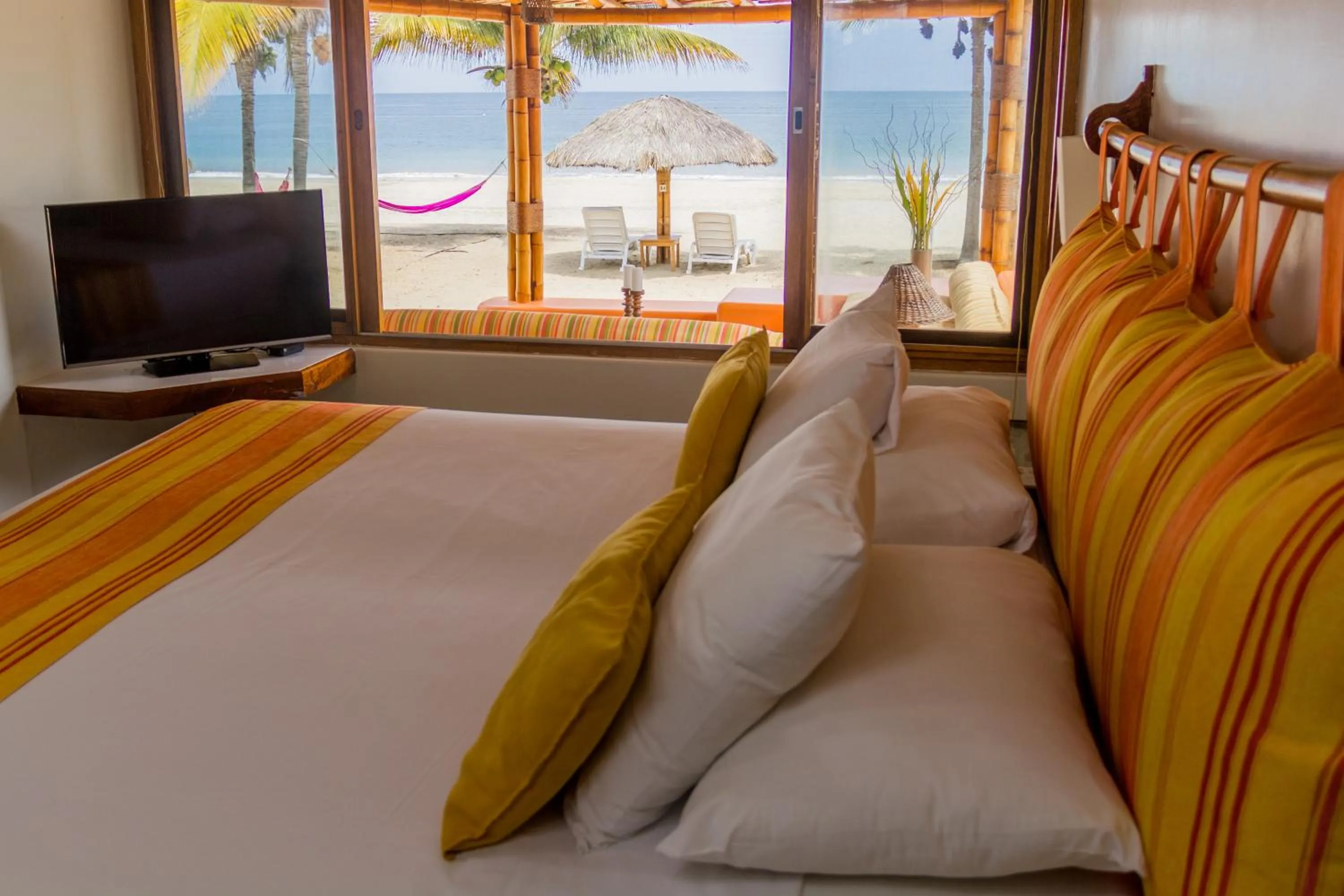 Bed in Punta Sal Suites & Bungalows Resort