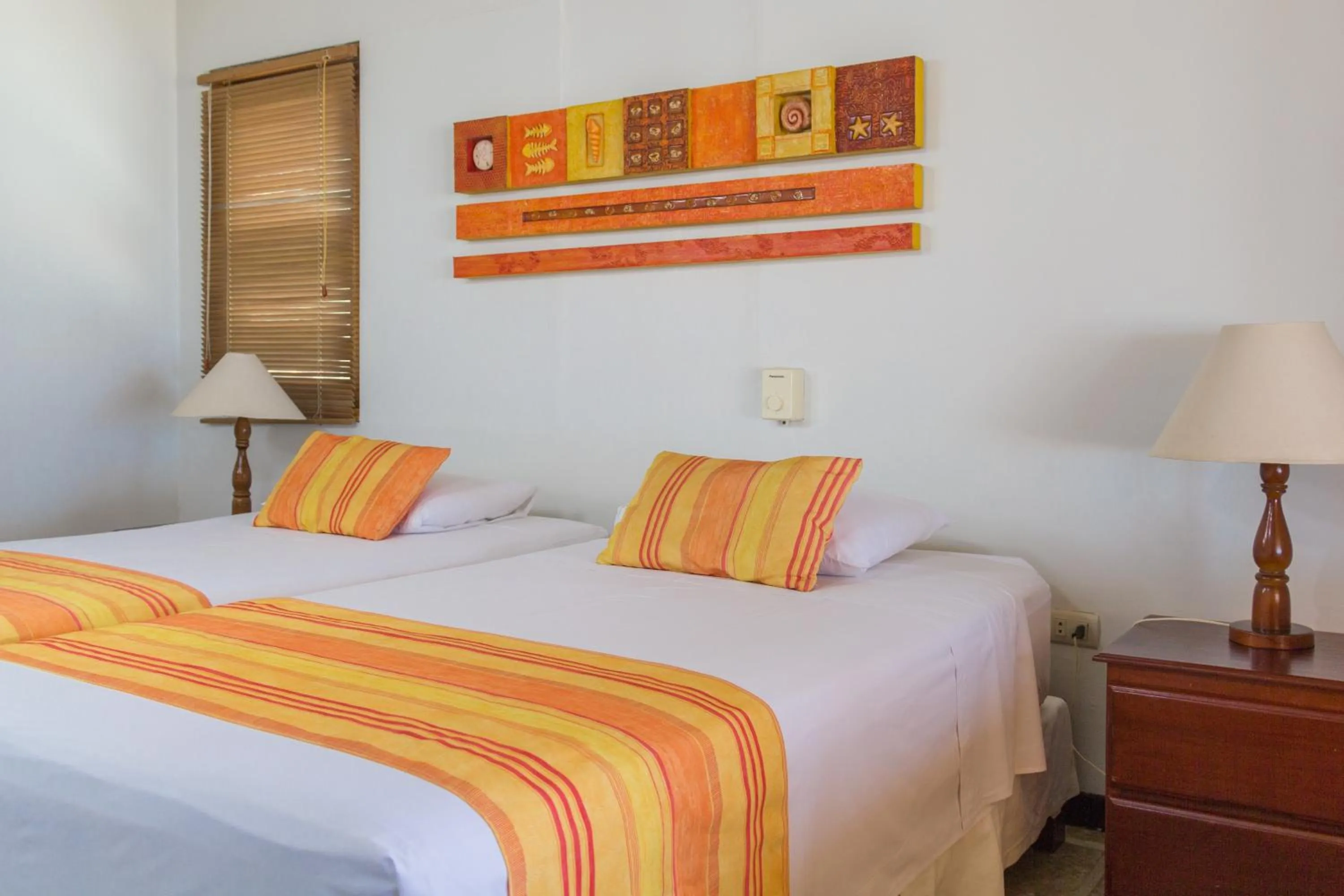Bed in Punta Sal Suites & Bungalows Resort
