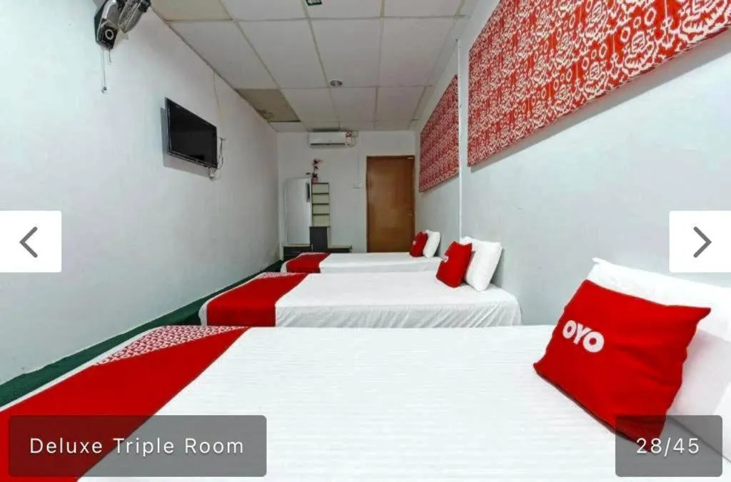 Bed in SYAHIRAH HOTEL