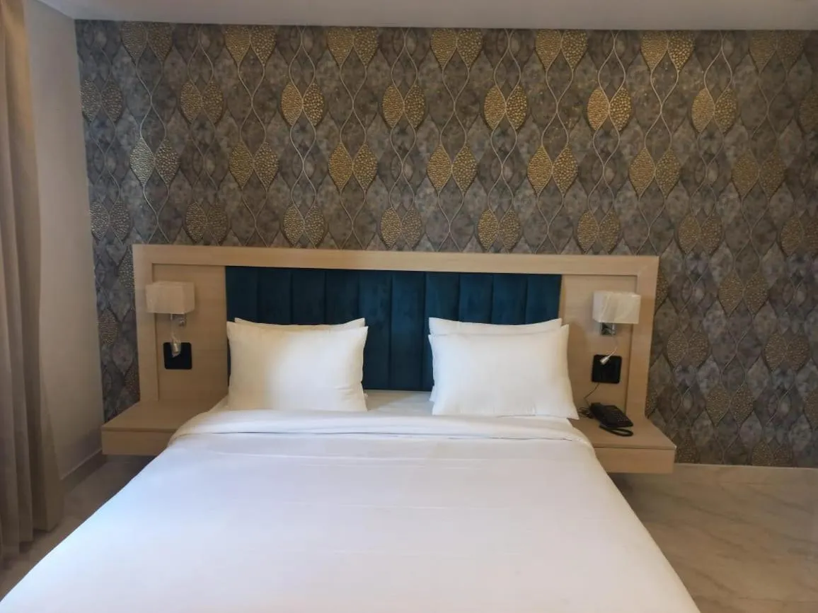 Bed in Hotel Holiday Grand