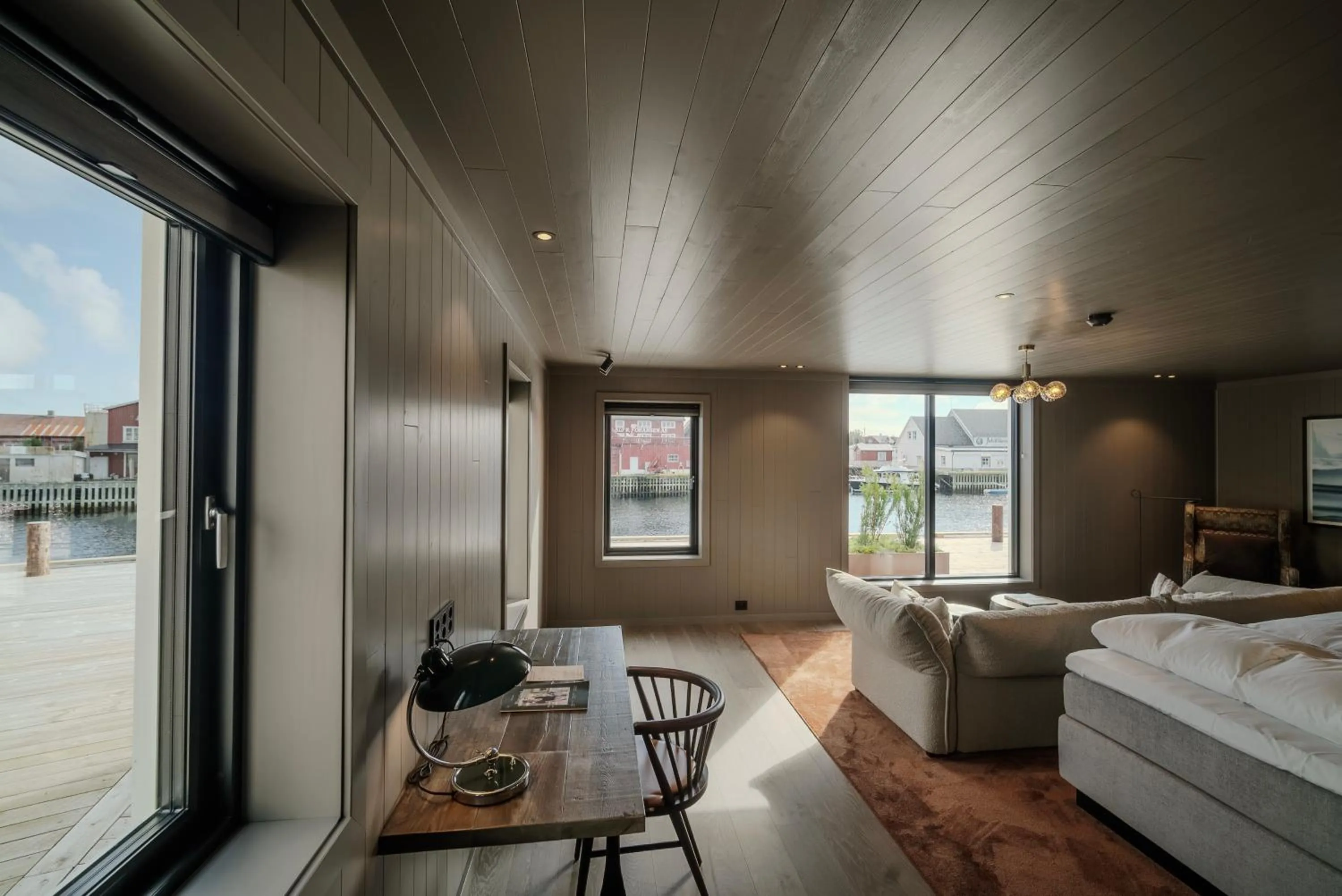 Living room, Bed in Henningsvær Bryggehotell - by Classic Norway Hotels