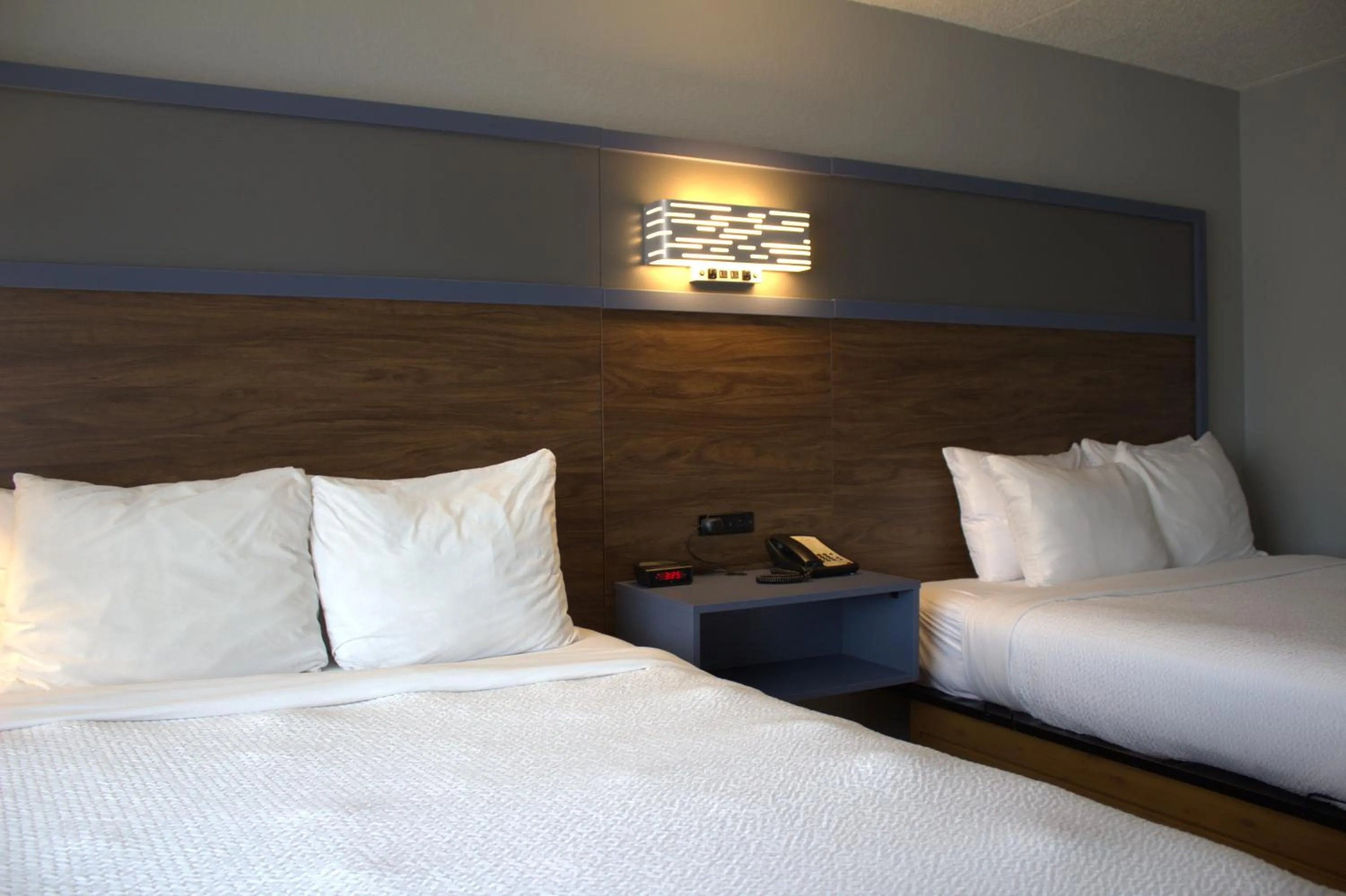 Bed in AmericInn by Wyndham Worthington