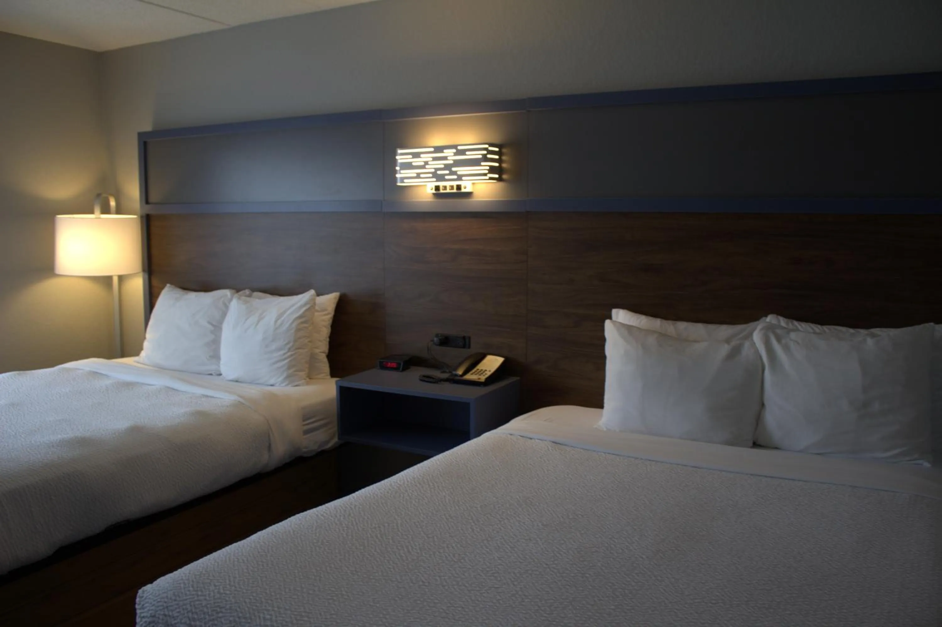 Bed in AmericInn by Wyndham Worthington