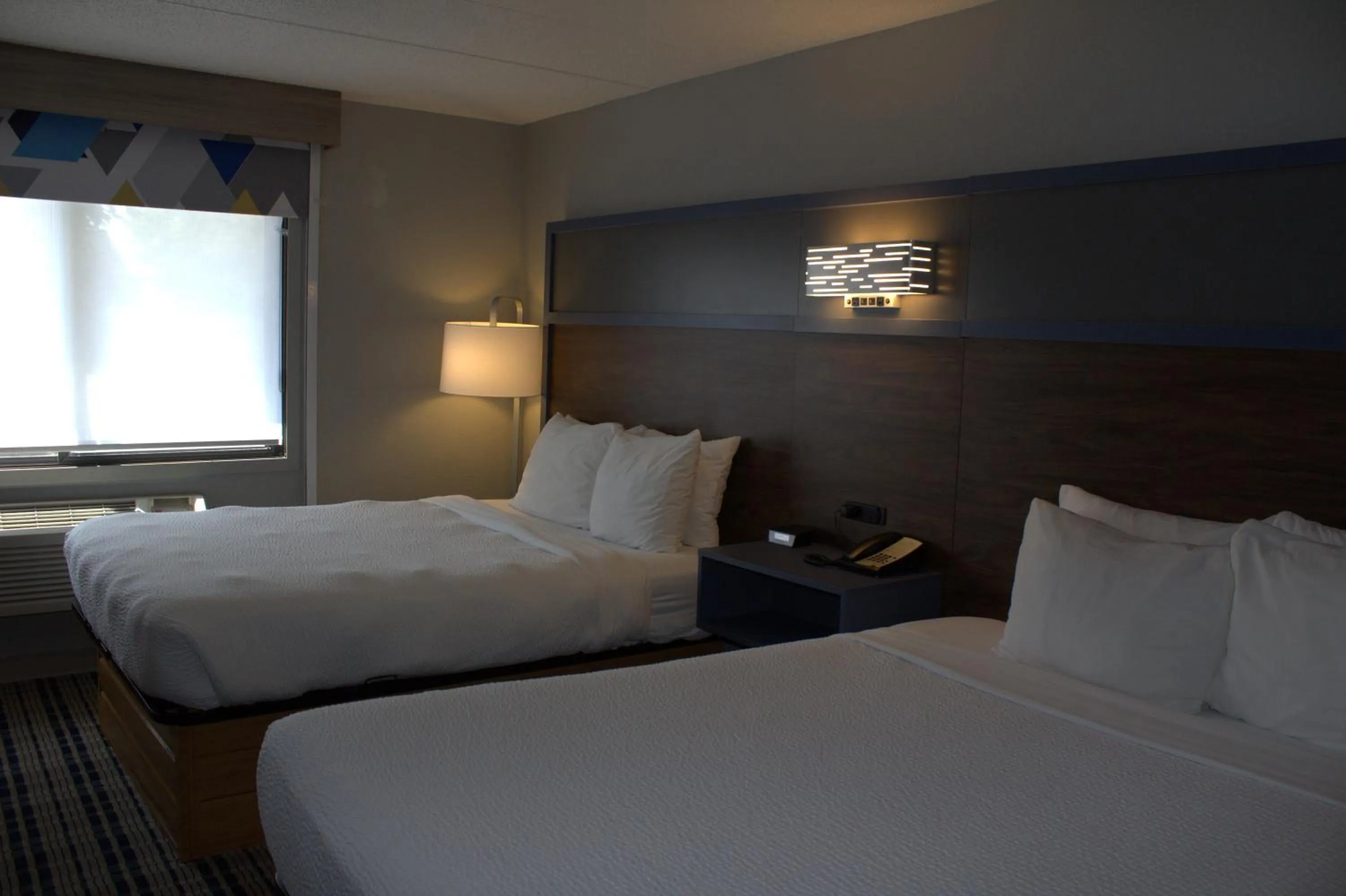 Bed in AmericInn by Wyndham Worthington