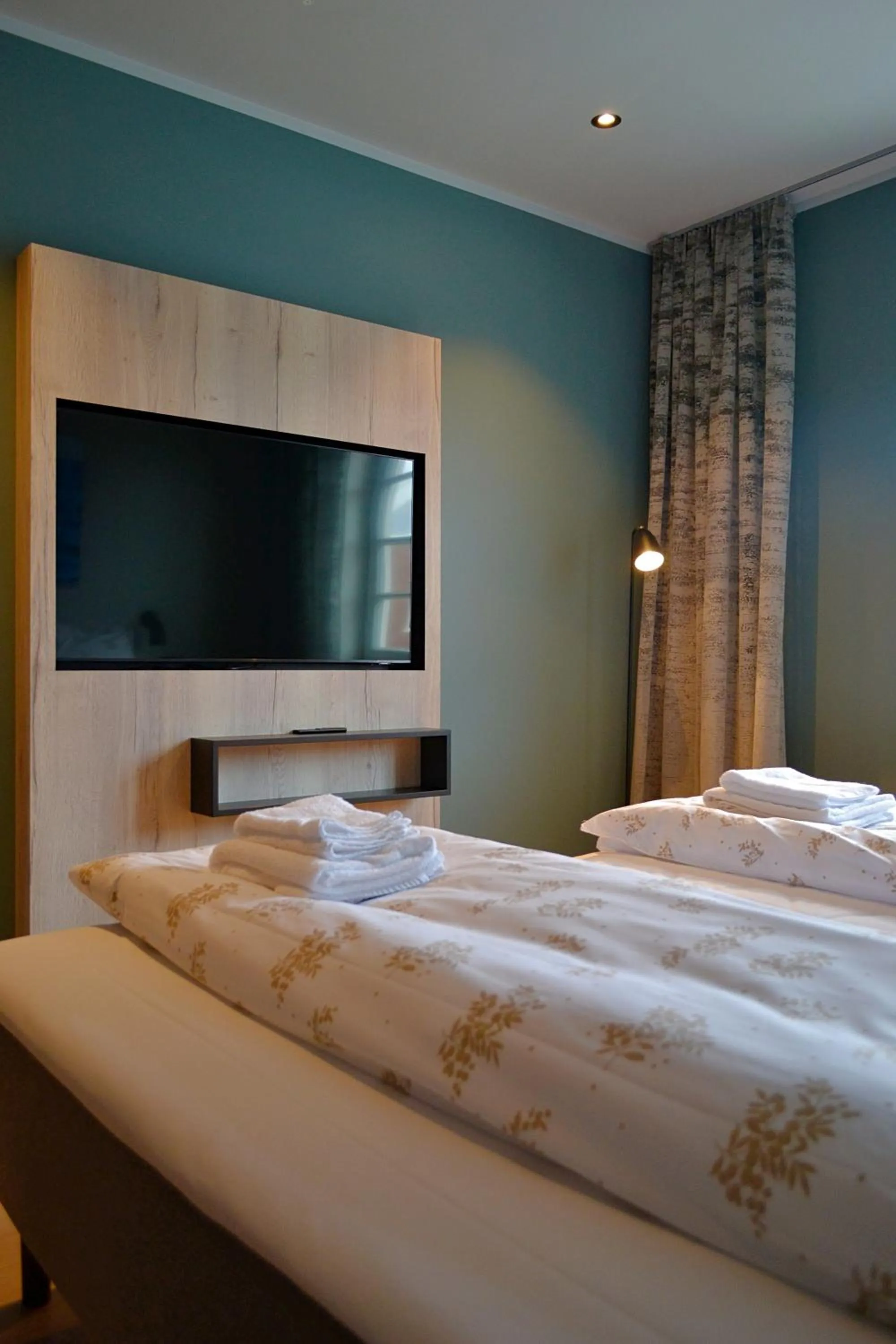 Bed in Andenes Suitehotel