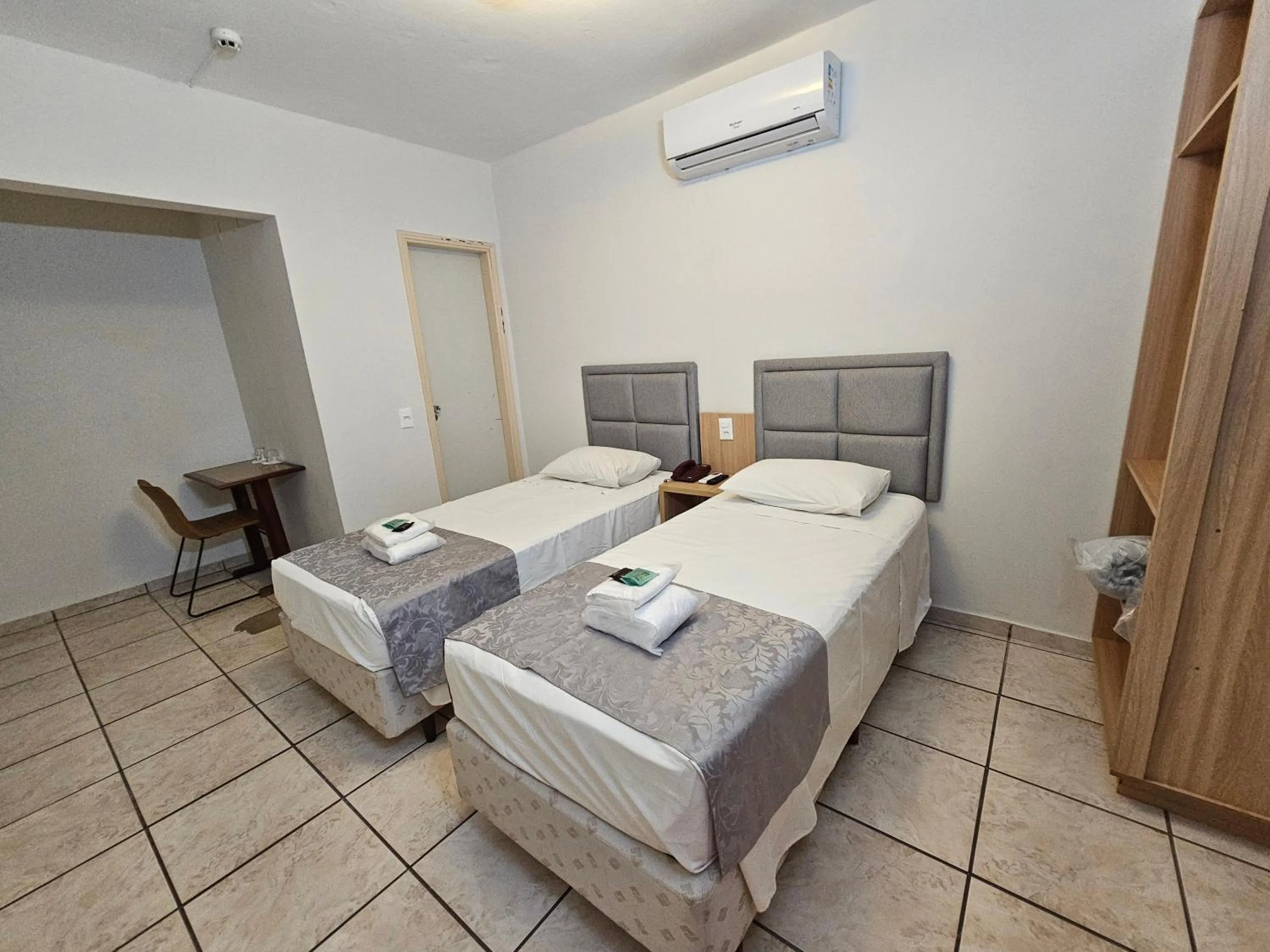 Bed in Optimum Plaza Hotel