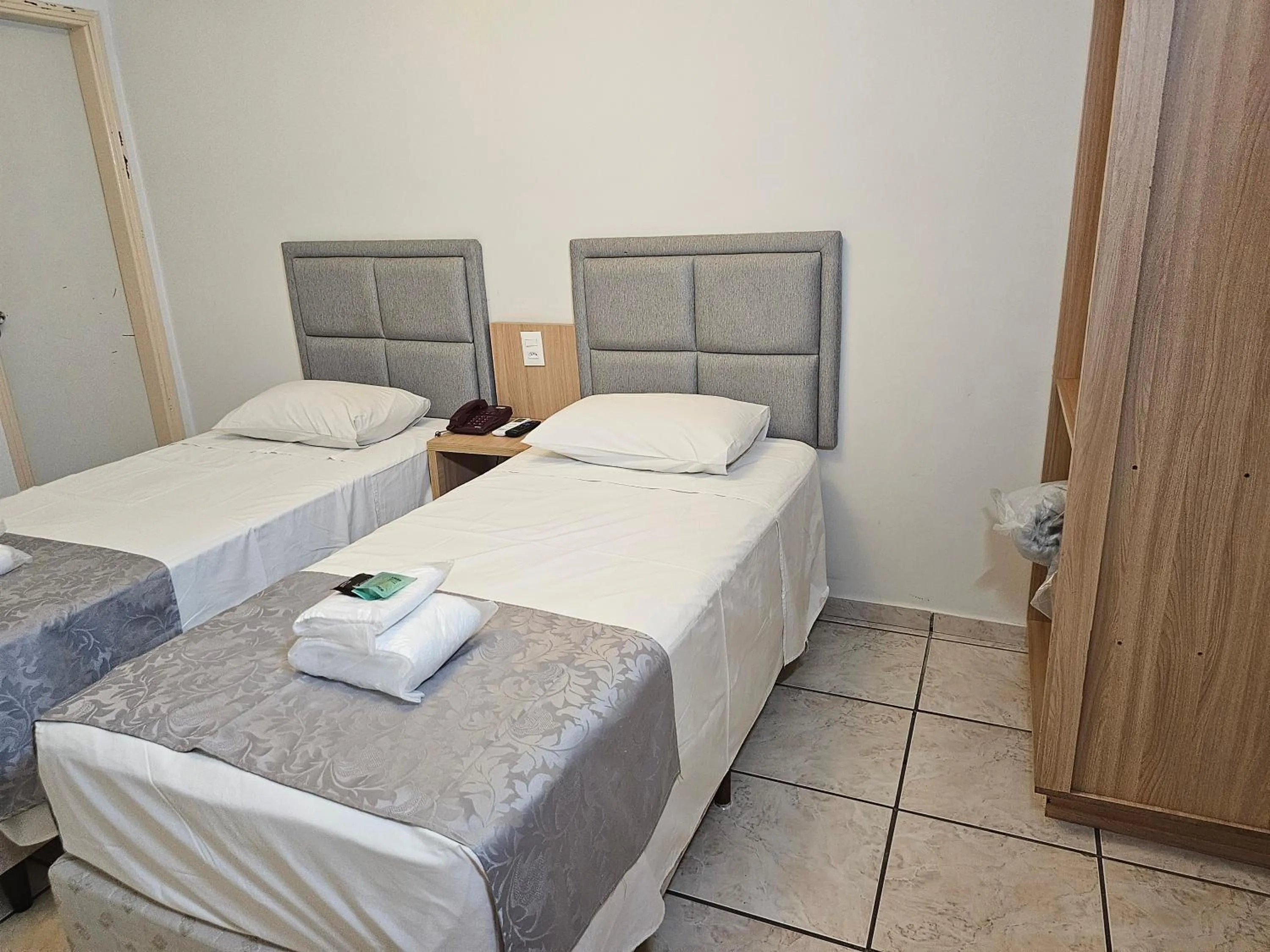 Bed in Optimum Plaza Hotel