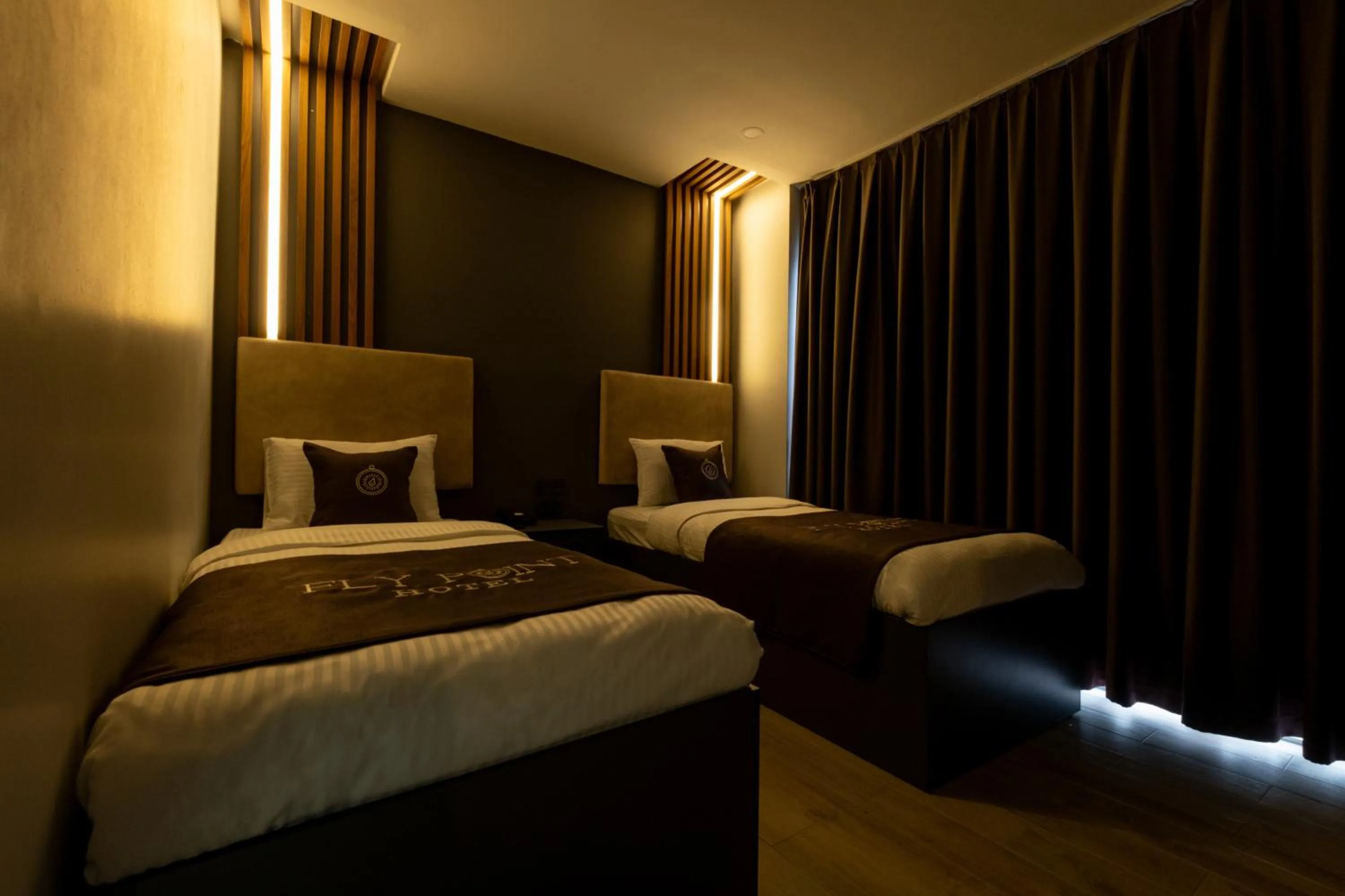 Bed in FLY POINT AIRPORT HOTEL