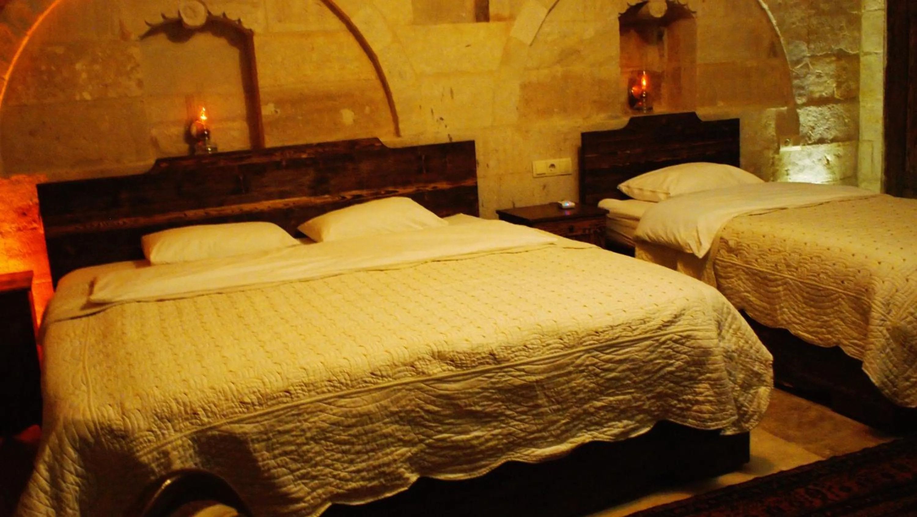 Bed in Family Cave Suite Hotel