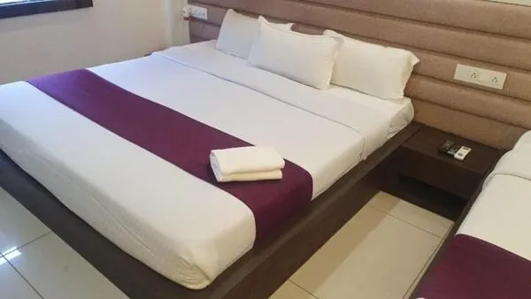 Bed in Hotel Siddhali Inn