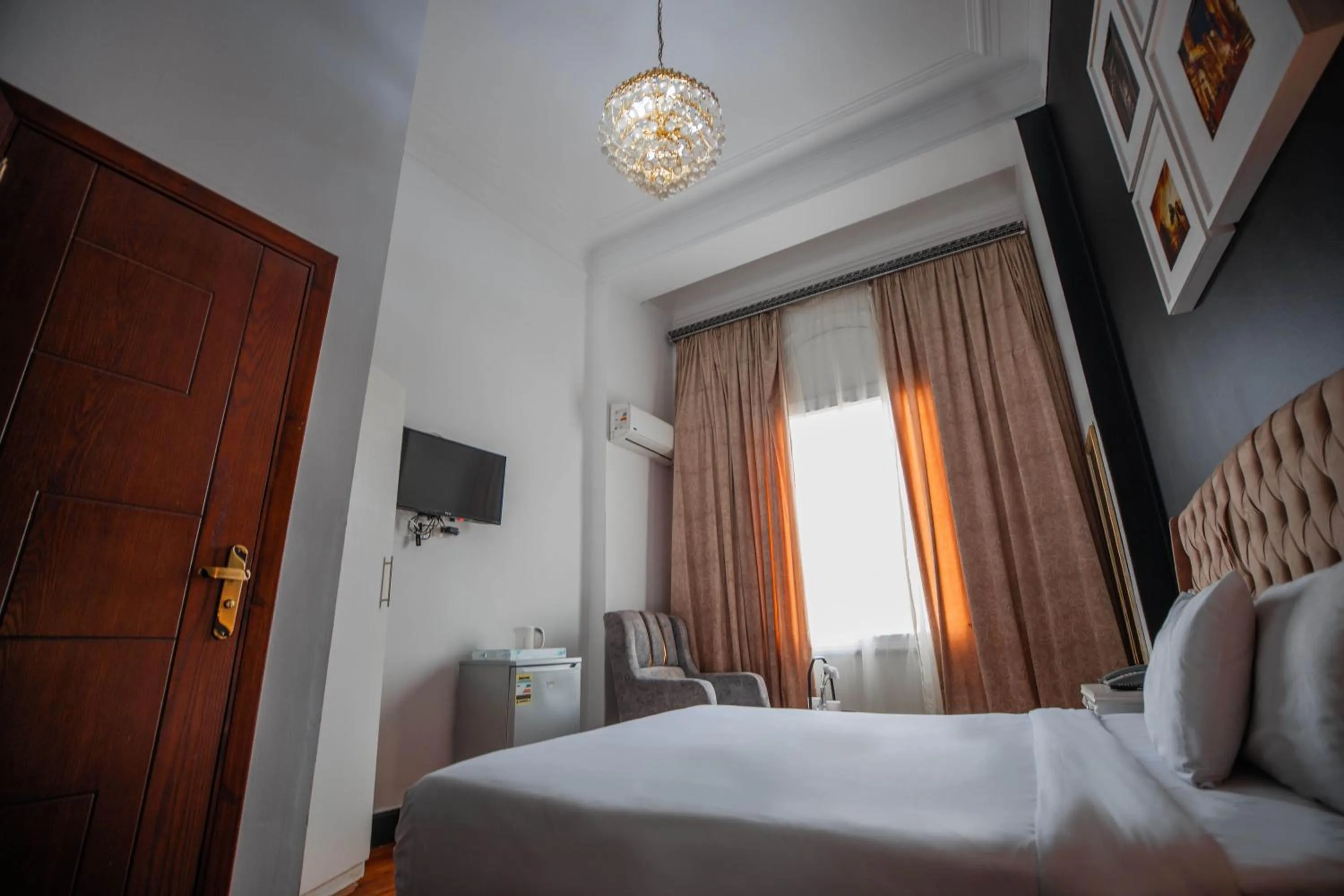 Communal lounge/ TV room in The Square Boutique Hotel