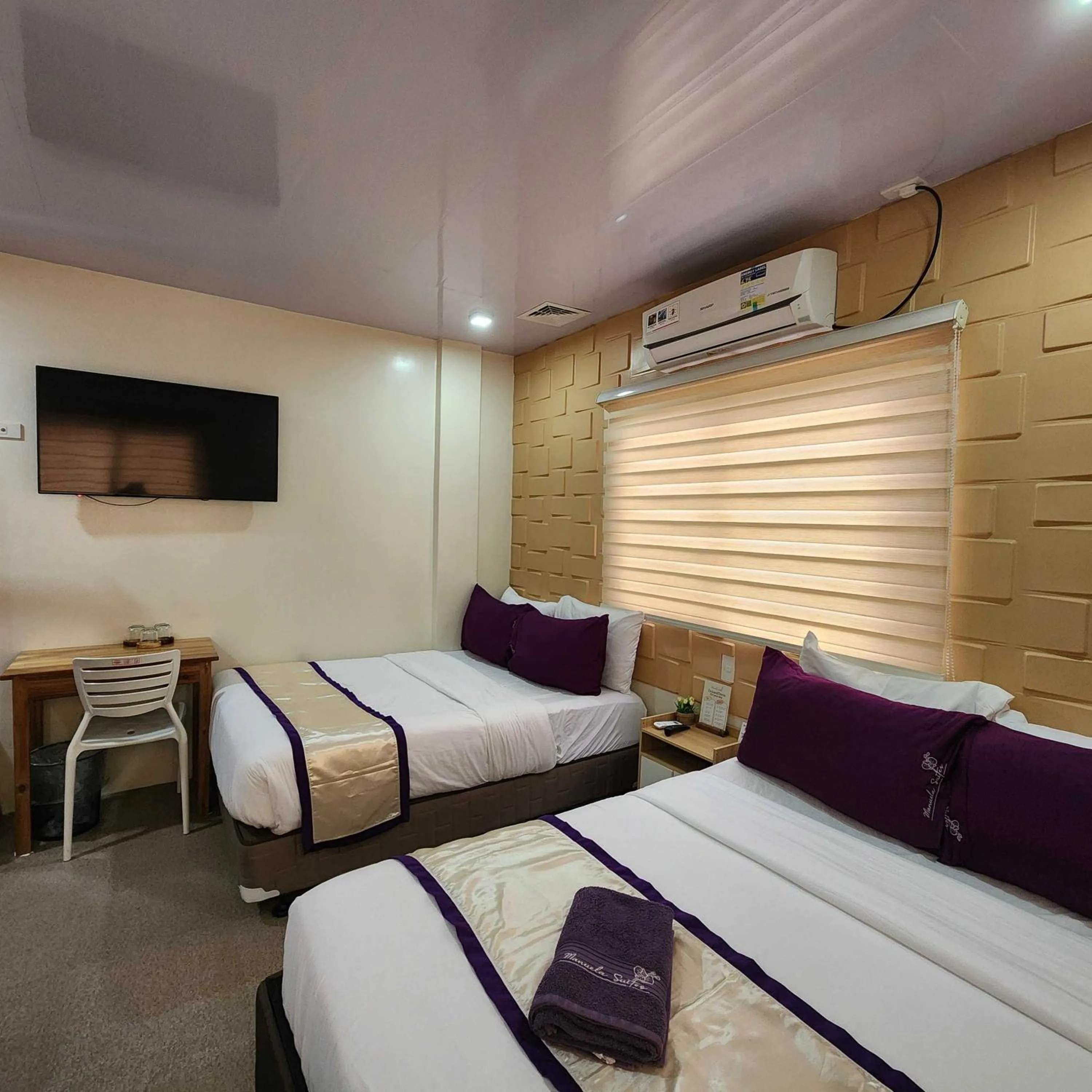 Bed in Manuela Suites Puerto Princesa near Airport