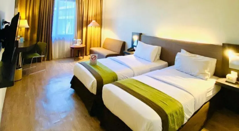 Bed in Grand Cemara Hotel