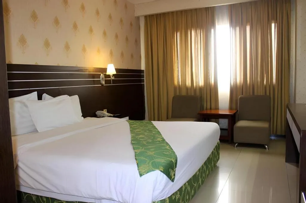 Bed in Grand Antares Hotel