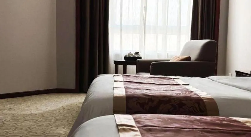 Bed in Fujian Galaxy Garden Hotel