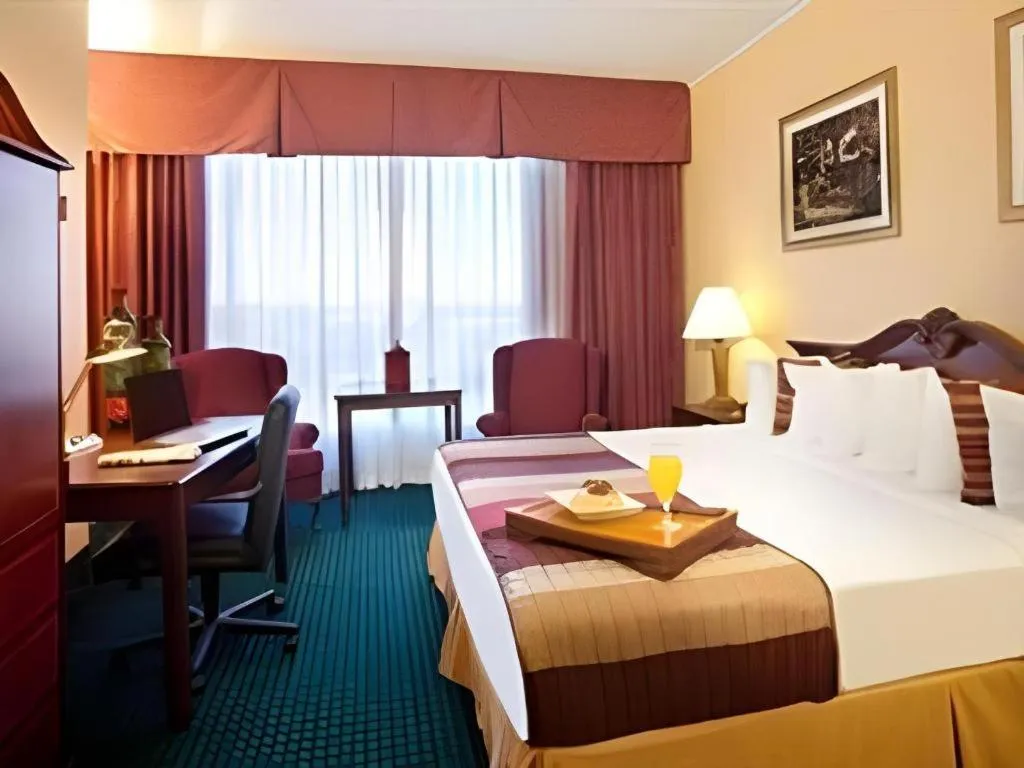 Bed in Magnuson Grand Conference Hotel