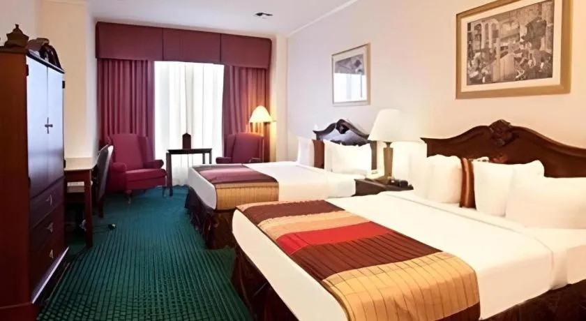 Bed in Magnuson Grand Conference Hotel