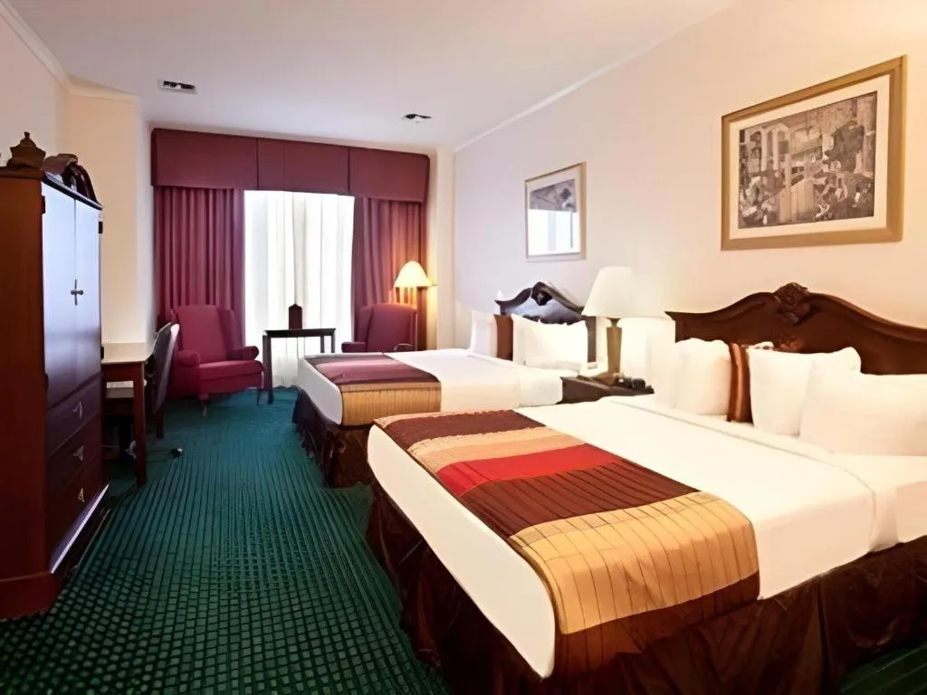 Bed in Magnuson Grand Conference Hotel