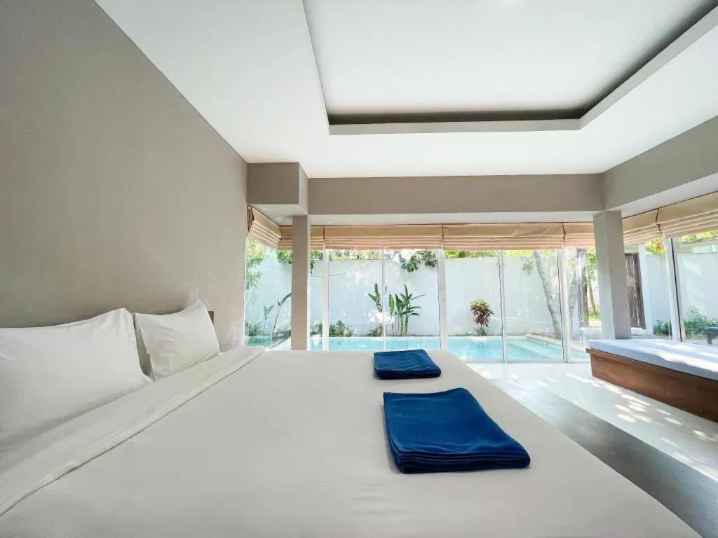 Bed in The Living Pool Villas