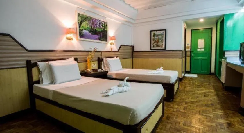 Bed in Family Country Hotel and Convention Centre