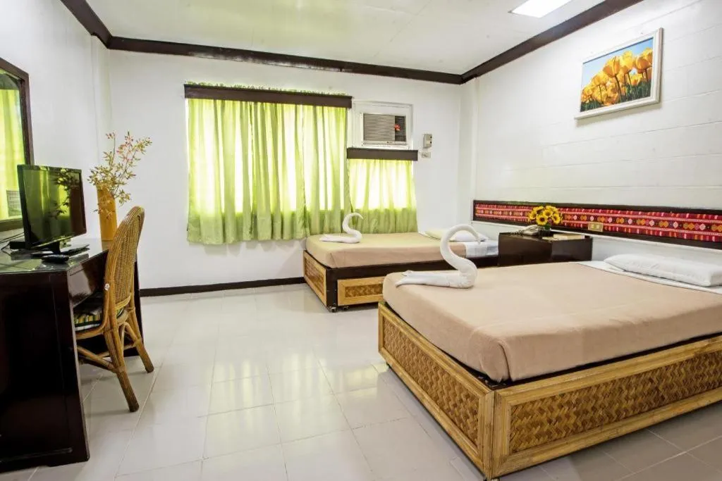 Bed in Family Country Hotel and Convention Centre