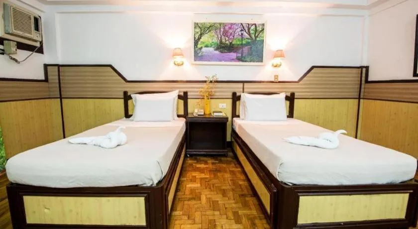 Bed in Family Country Hotel and Convention Centre