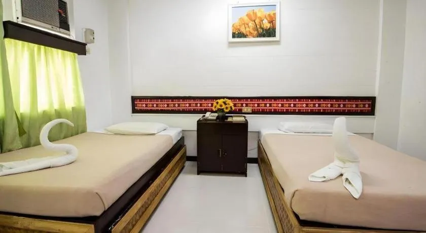 Bed in Family Country Hotel and Convention Centre