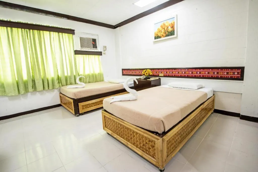 Bed in Family Country Hotel and Convention Centre